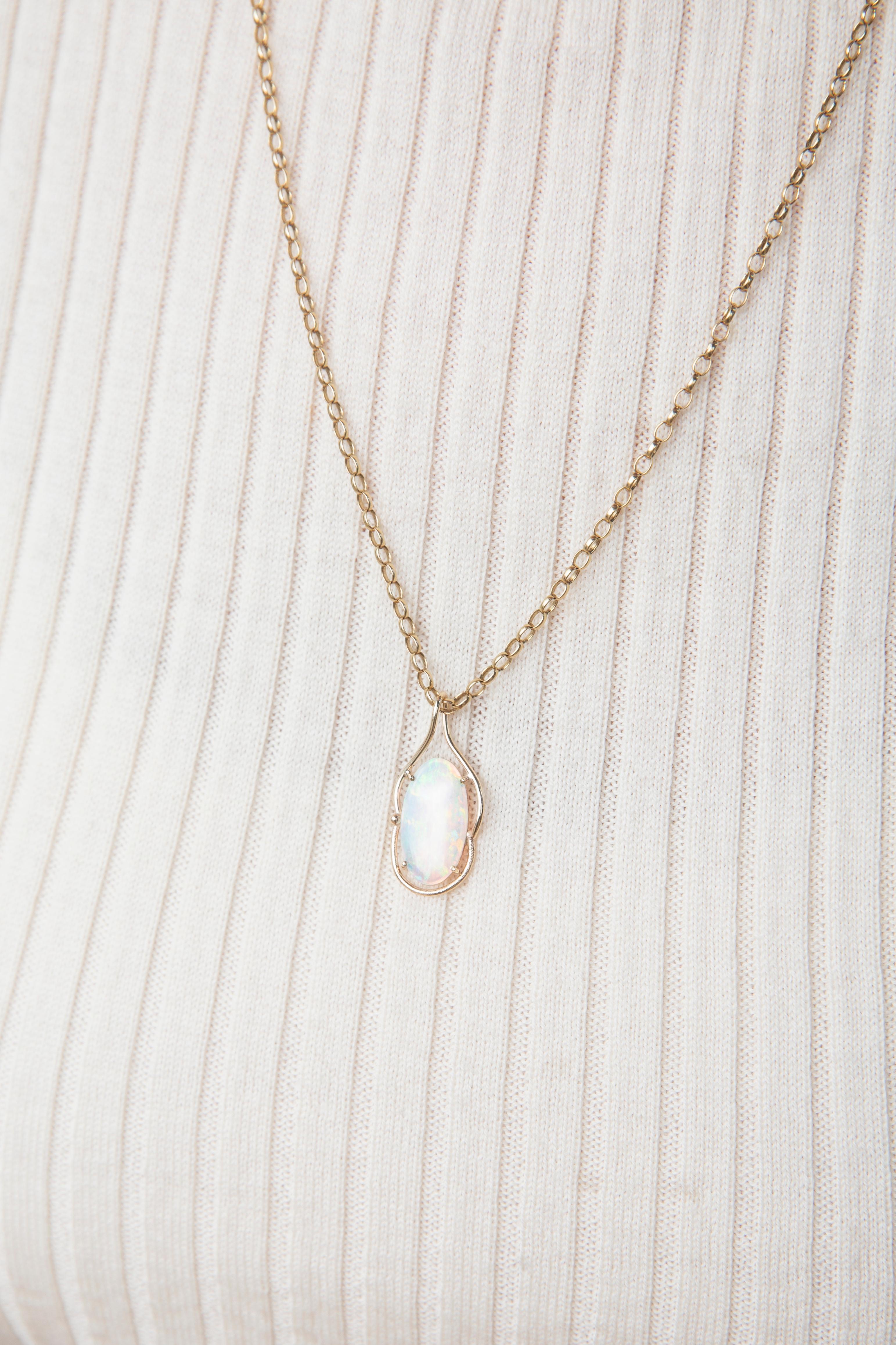 Crafted in 9 carat yellow gold, this opulent pendant features a gorgeous oval Australian crystal opal alive dreamy green and orange play of colour and set into an elegant wire frame. Her name is The Hannah Pendant. She is threaded with an elegant