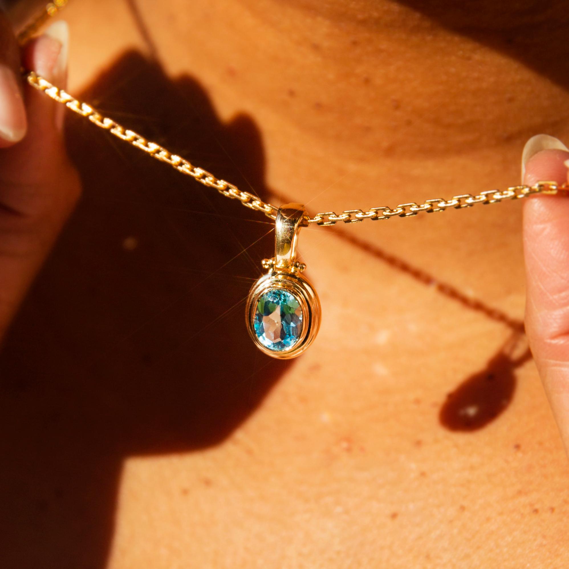 Crafted in 9 carat gold, The Mila Pendant is a sweet offering blessed with a sky blue topaz as clear and bright as a warm summer's day. A lovely inclusion in any collection, she is threaded with a sensual fine chain.

The Mila Pendant & Chain Gem