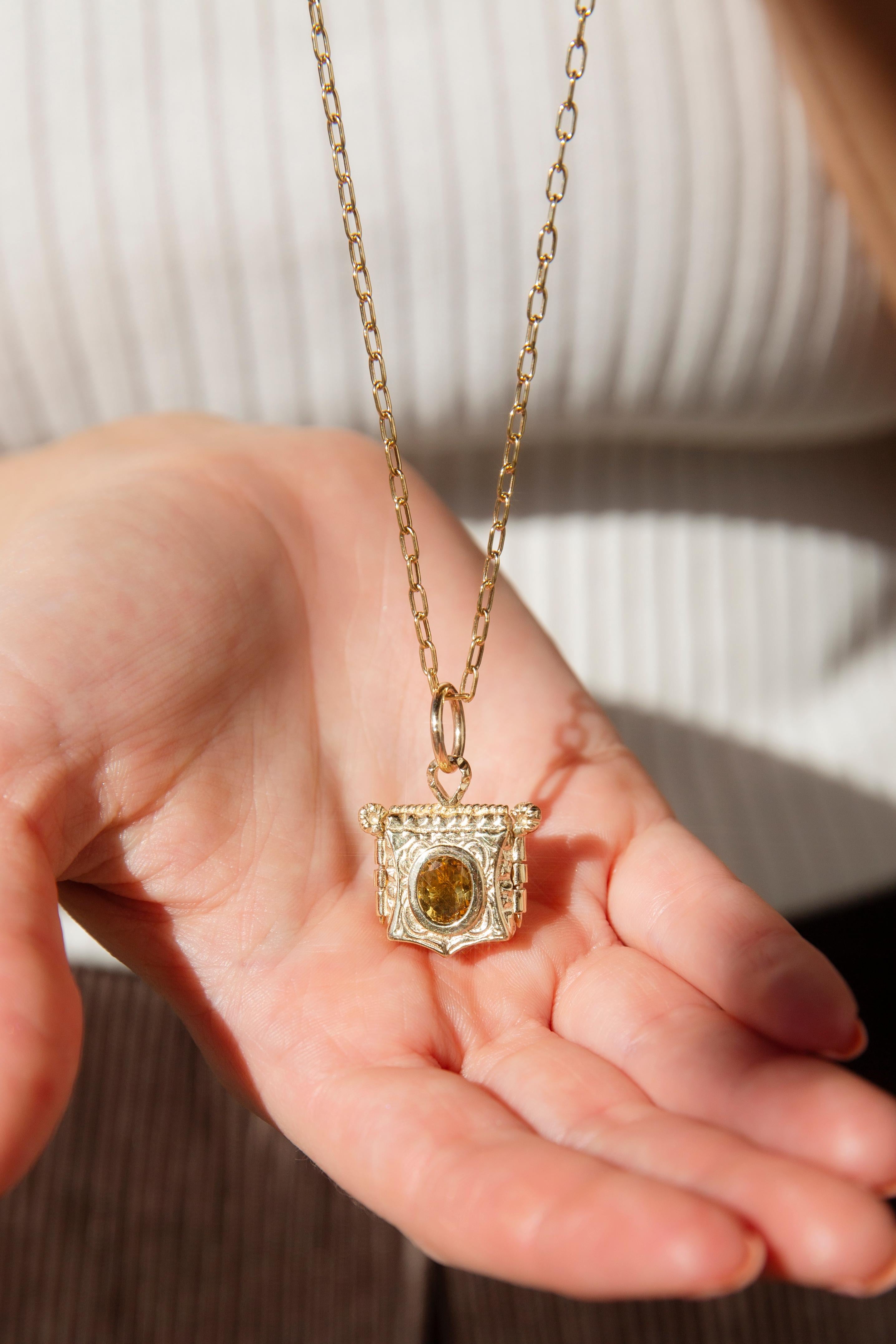 Expertly crafted in 18 carat gold, The Albertine Locket is a sweet gift. Her gorgeous pinned locket frames the most vivid of citrines and is etched with ribbons of swirling gold. Within is a space to store the photos of loved ones that find their