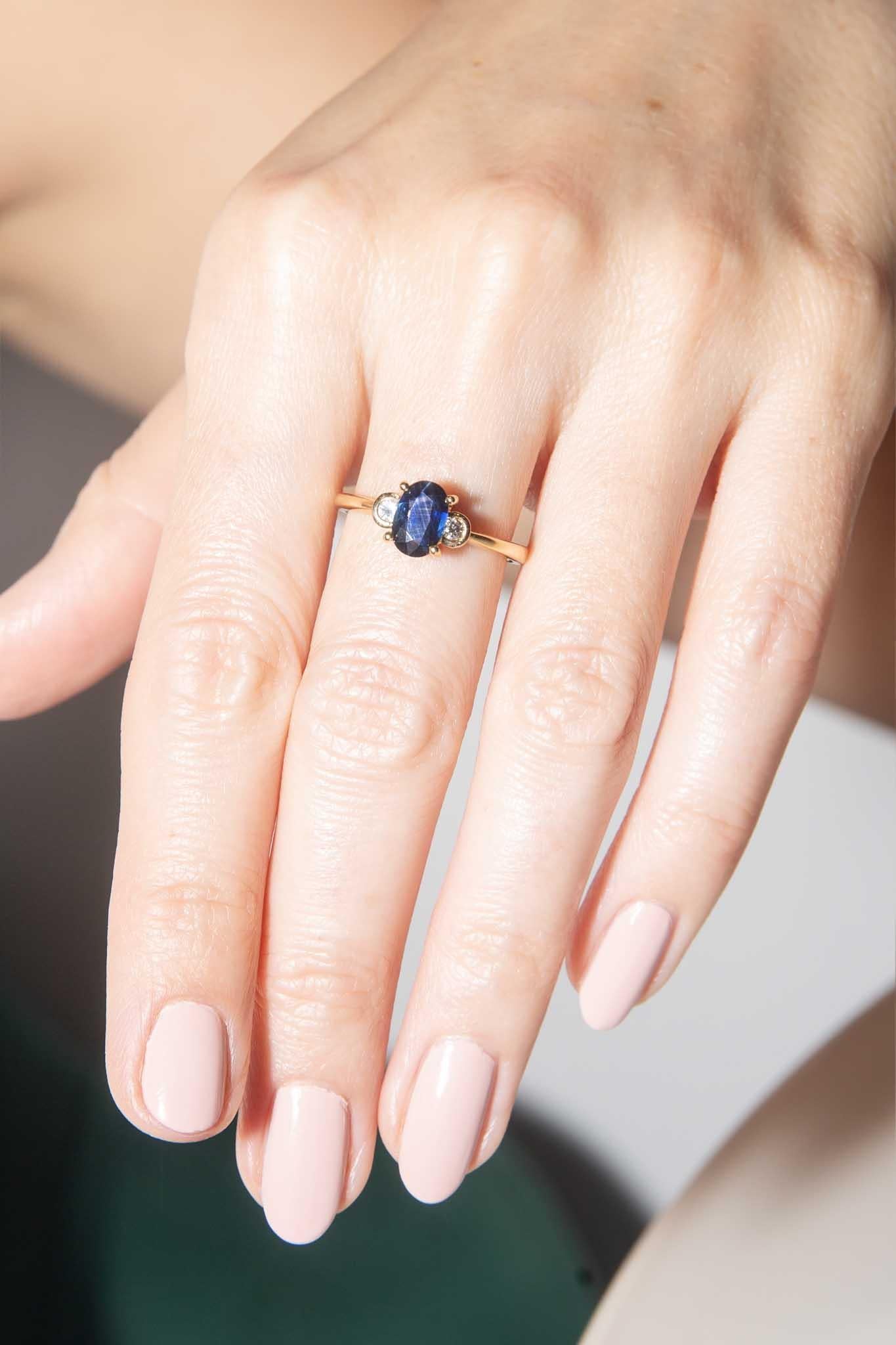 Crafted in 9 carat gold, The Robyn Ring is a classic design with her deep blue sapphire enhanced by a sparkling diamond on either side. A lovely gift for your someone special.

The Robyn Ring Gem Details
The faceted oval deep blue oval sapphire is
