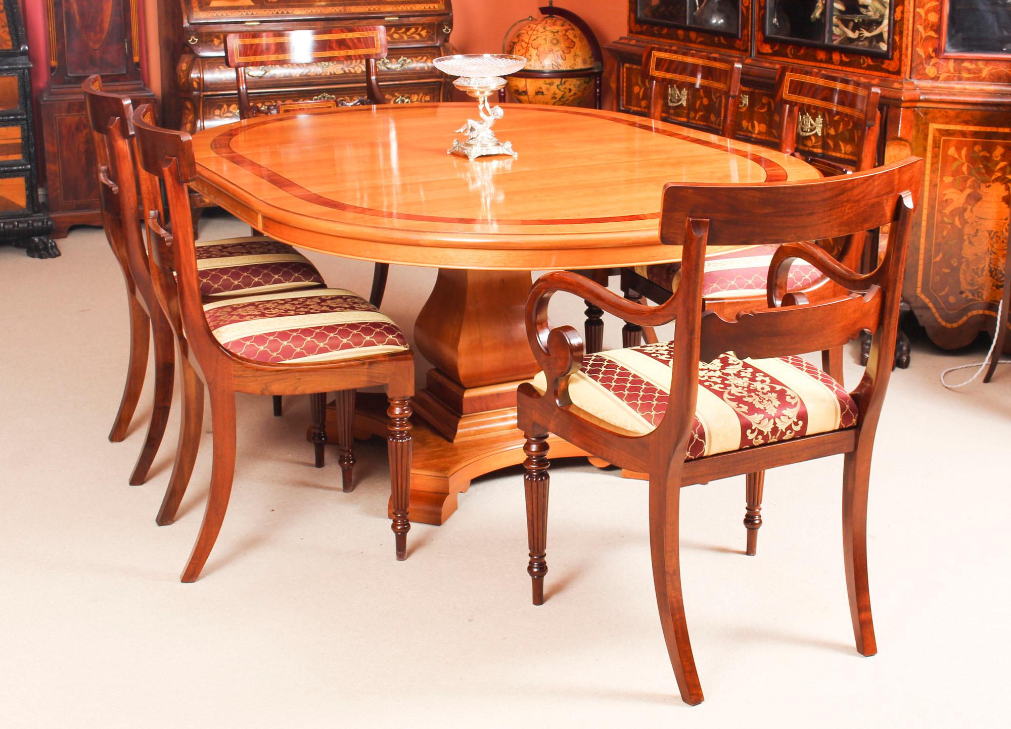 This is a magnificent vintage dining set comprising a cherrywood dining table by the renowned Norwich cabinet maker Charles Barr and a set of eight dining chairs, dating from the late 20th century.

This beautiful table is circular in shape when