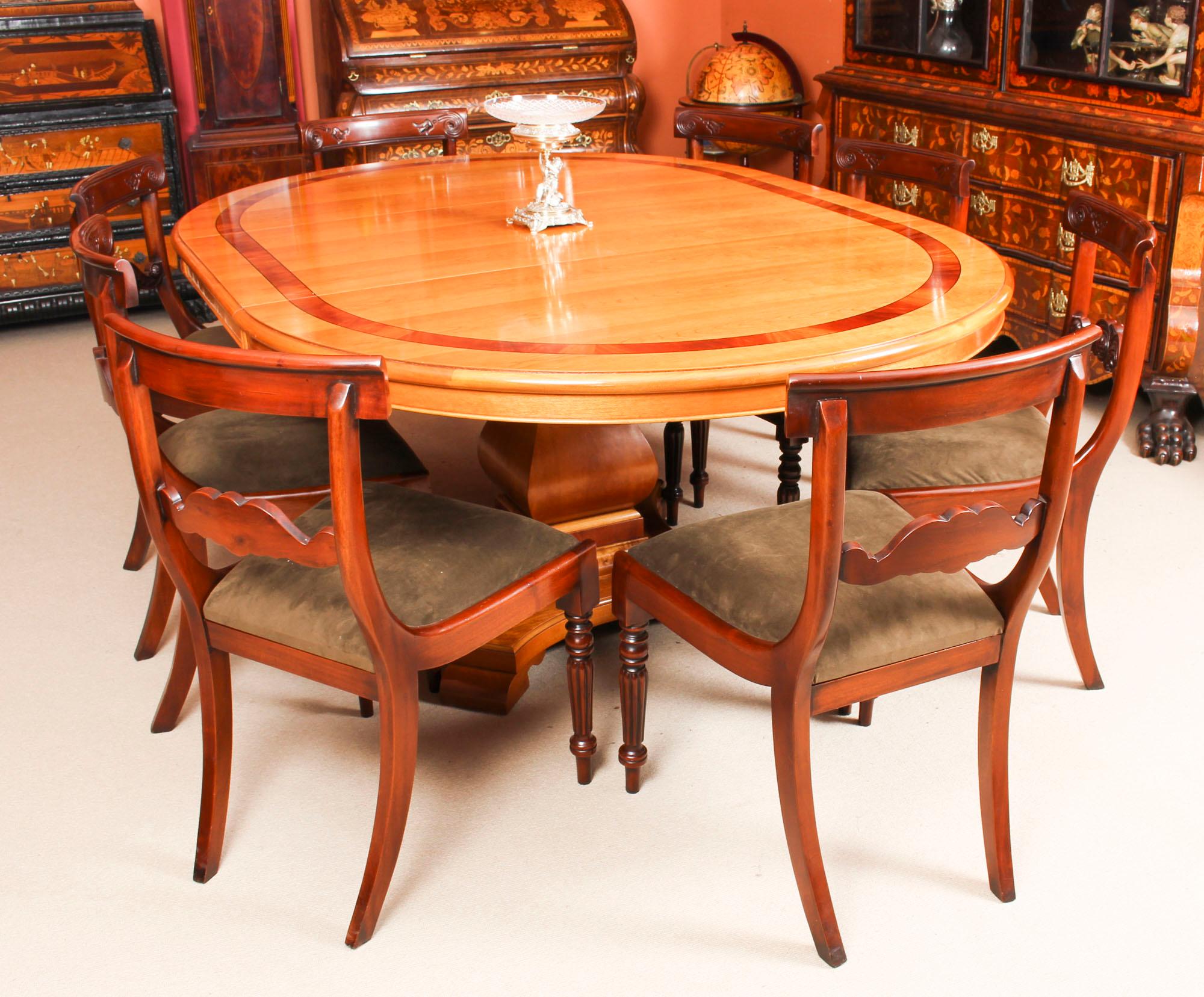 This is a magnificent vintage dining set comprising a cherry wood dining table by the renowned Norwich cabinet maker Charles Barr and a set of eight dining chairs, dating from the late 20th century.

This beautiful table is circular in shape when