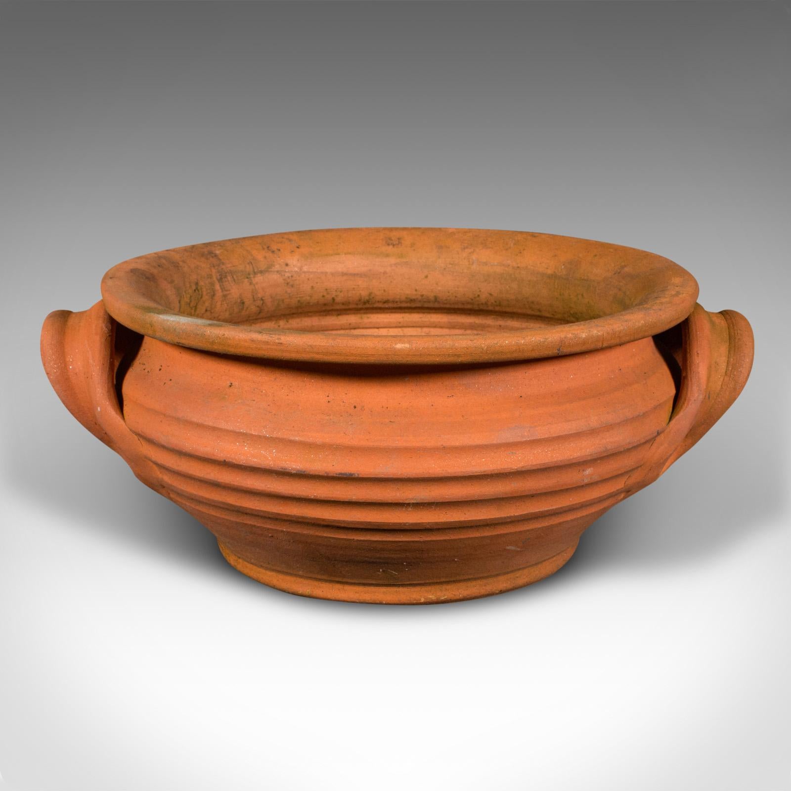 This is a vintage circular jardiniere. An Italian, terracotta garden or patio planter pot, dating to the mid 20th century, circa 1960.

Fascinating cylindrical form with great colour
Displays a desirable aged patina and in good order
Terracotta
