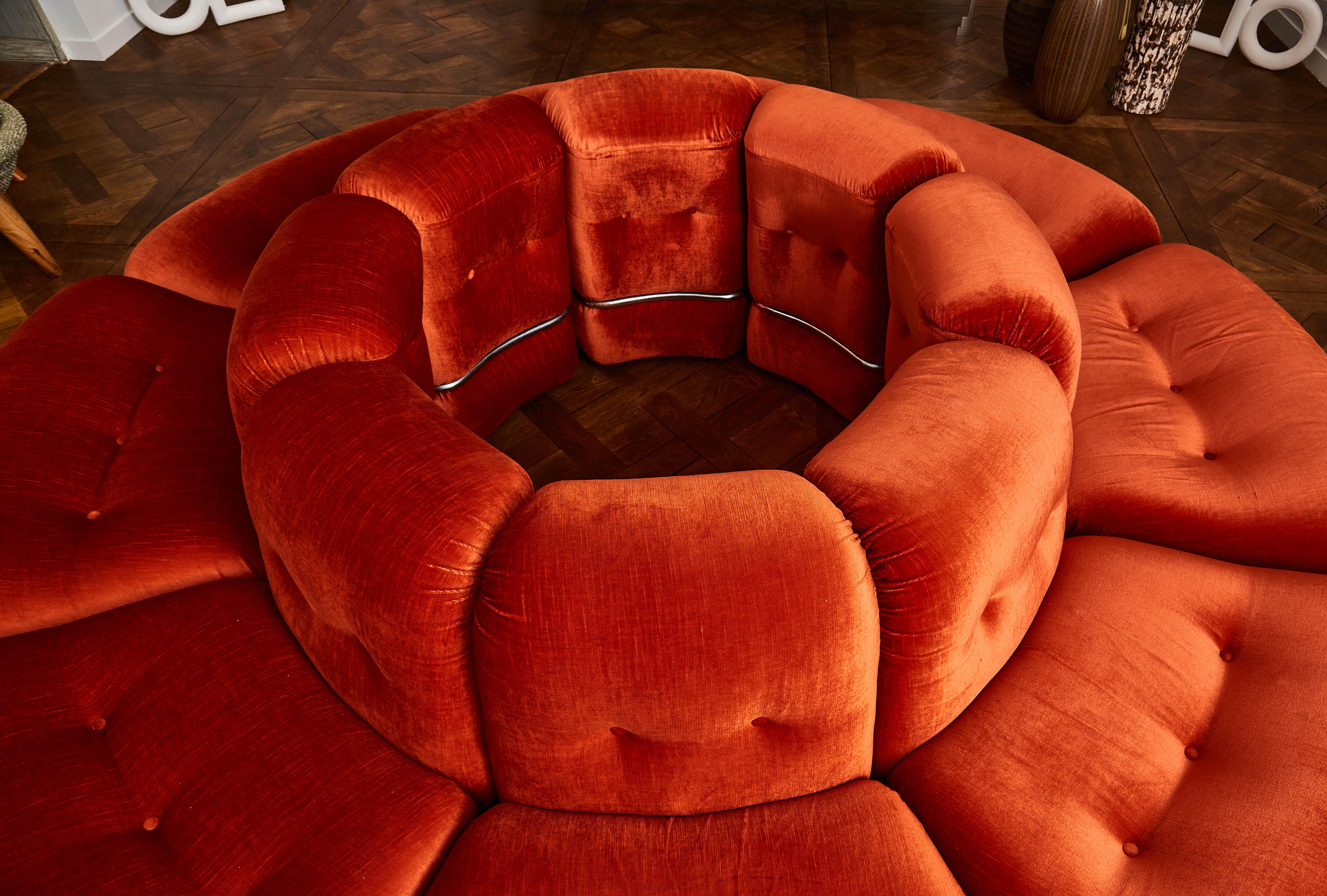 Vintage circular sofa upholstered with its original orange velvet, composed by 8 separable parts, hooded with steel. Italy, 1980s.
 