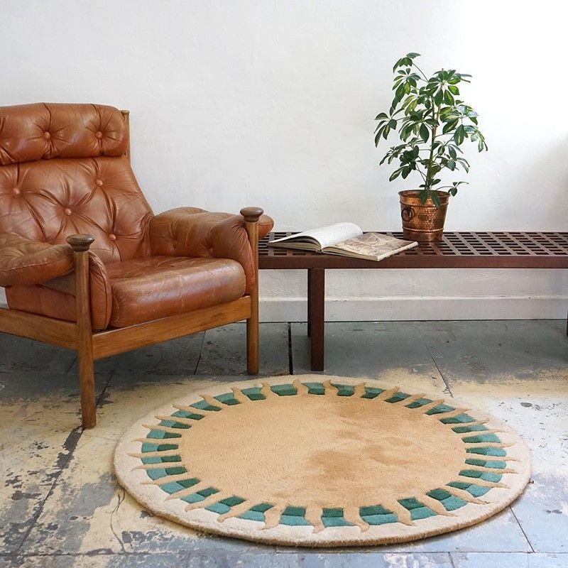 Mid century hand-tufted wool sun carpet.

A stylised golden sun radiating over a green, teal and buff background.

Deep pile luxuriousness from the high-quality French manufacturer.

It is in very good vintage condition with only minor wear