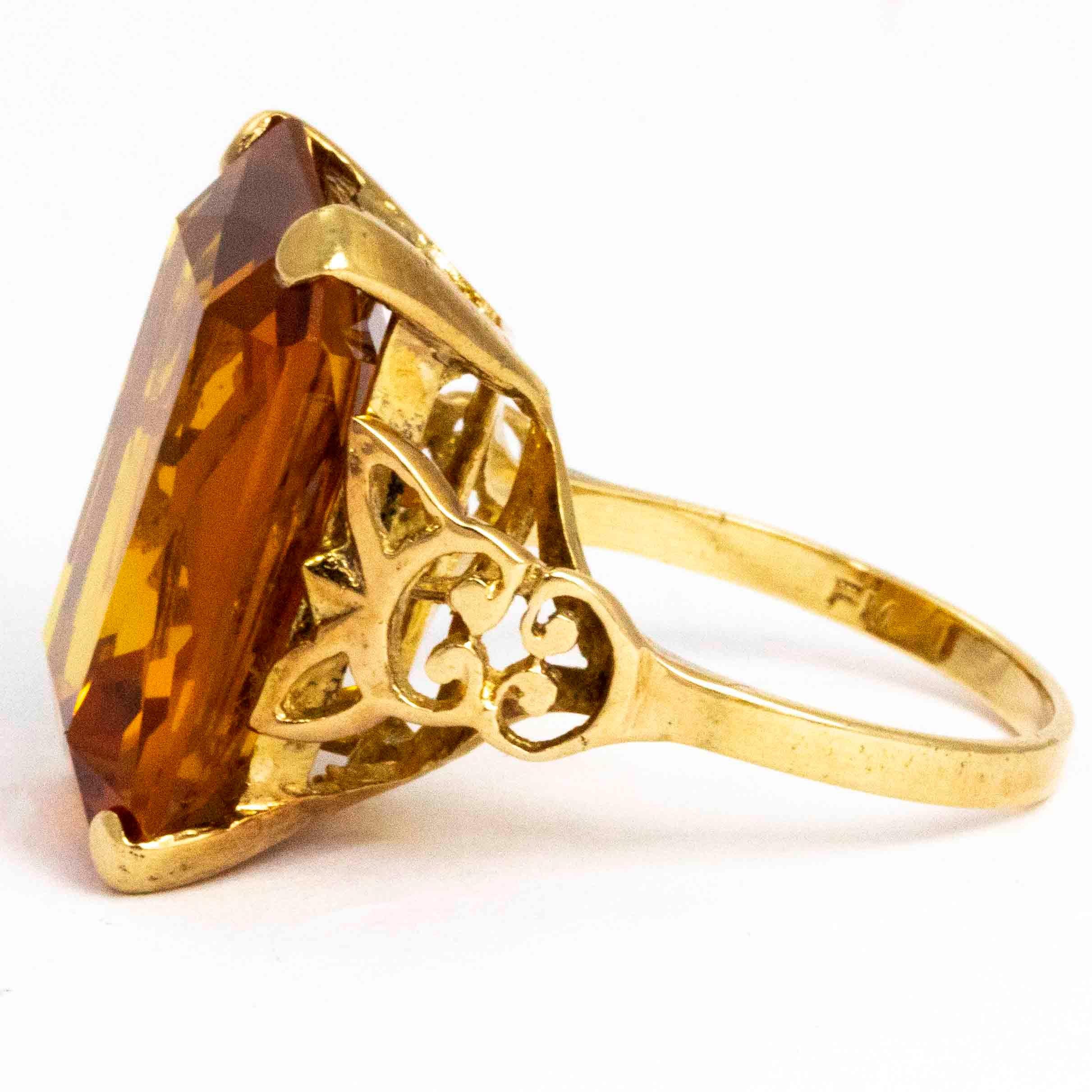 The deep, rich colour of this citrine make this ring a real show stopper. It has a wonderful cut which reflects the light beautifully and is held in a very simple 9ct gold claw setting. The shoulders have gorgeous Art Deco style details which then