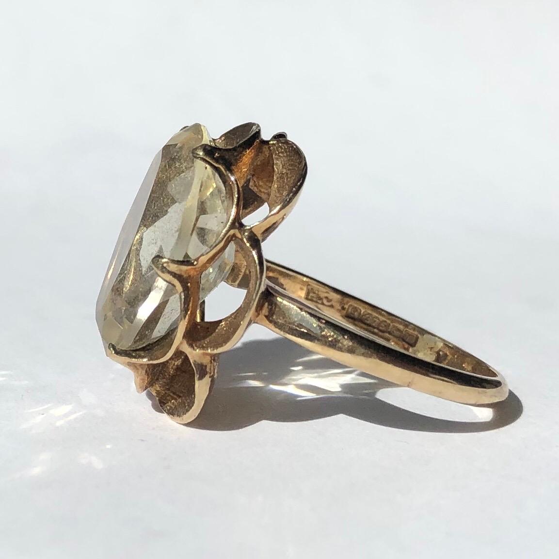 This decorative citrine ring is modelled in 9ct gold. The citrine stone is pale in colour and sits in a scalloped double row setting. 

Size: N or 6 3/4
Stone Dimensions: 16x 12.5mm 
Height Off Finger: 8mm 

Weight: 5.79g
