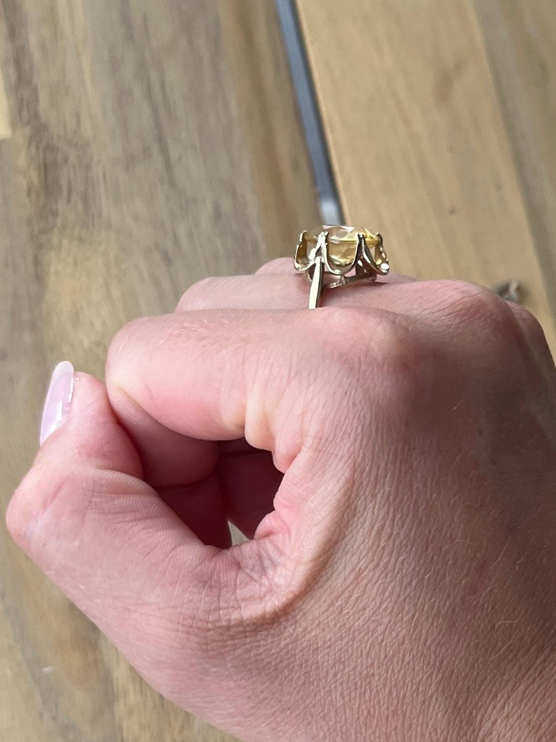 The gorgeous citrine stone is a bright yellow colour set in scalloped claws. Modelled in 9carat gold. Hallmarked London 1972.

Ring Size: L 1/2 or 6  
Stone Dimensions: 12x10.5mm
Height Off Finger: 8mm 

Weight: 3.1g