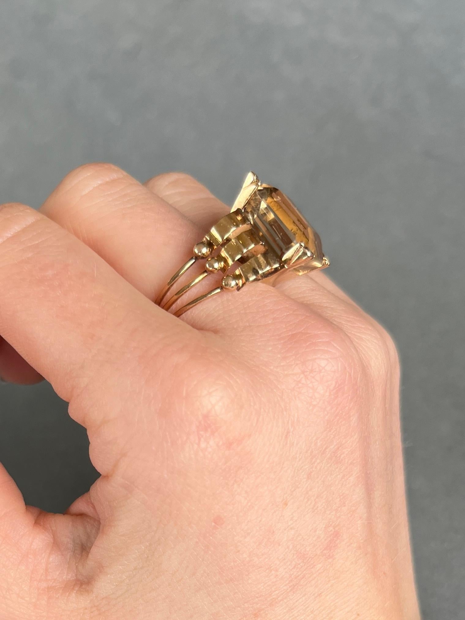 The gorgeous large citrine stone is a pale yellow colour set in decorative claws. The gallery is solid and the shoulders and band are made up of three bands of gold. All modelled in 9carat gold.

Ring Size: O or 7 1/4 
Stone Dimensions: