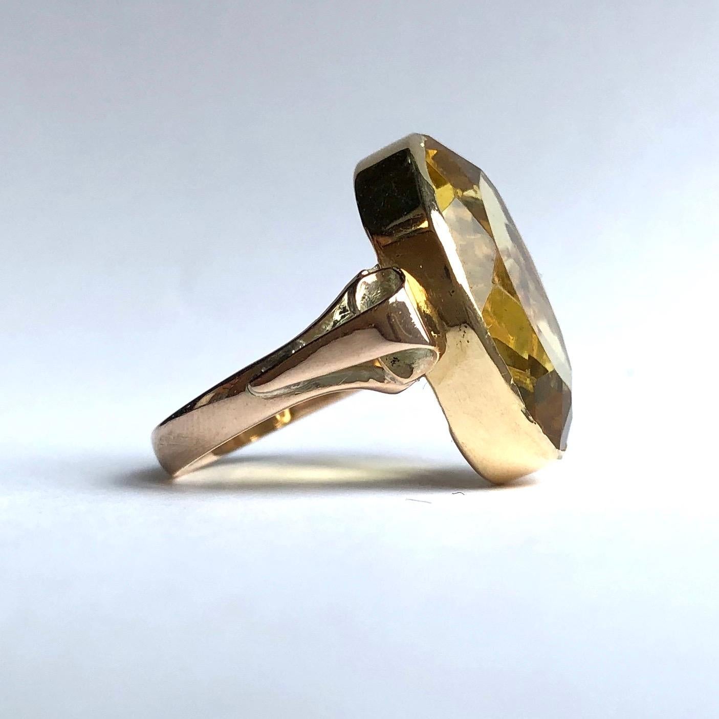 Sat between two scroll shoulders is a bright yellow citrine stone which is set within a simple 9ct gold setting. 

Ring Size: O or 7 1/4 
Stone Dimensions: 21x16mm 

Weight: 6.1g