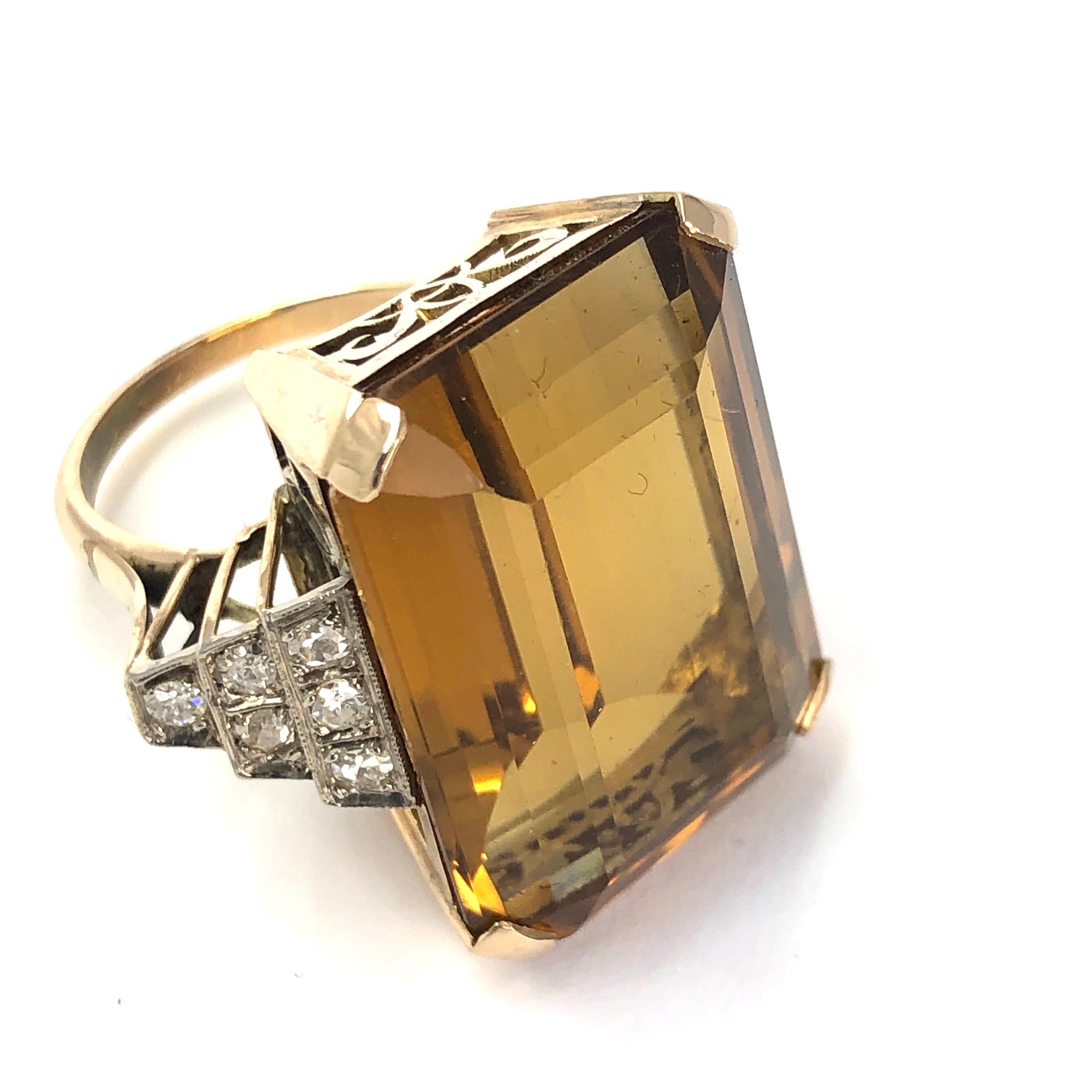 Set in this gorgeous Art Deco style setting is a giant amber coloured citrine stone. The stone is approximately 38ct and the ring also has sparkling shoulders holding 40pts worth of diamonds each. The diamonds are an H colour SI 1.

Ring Size: Q or 8