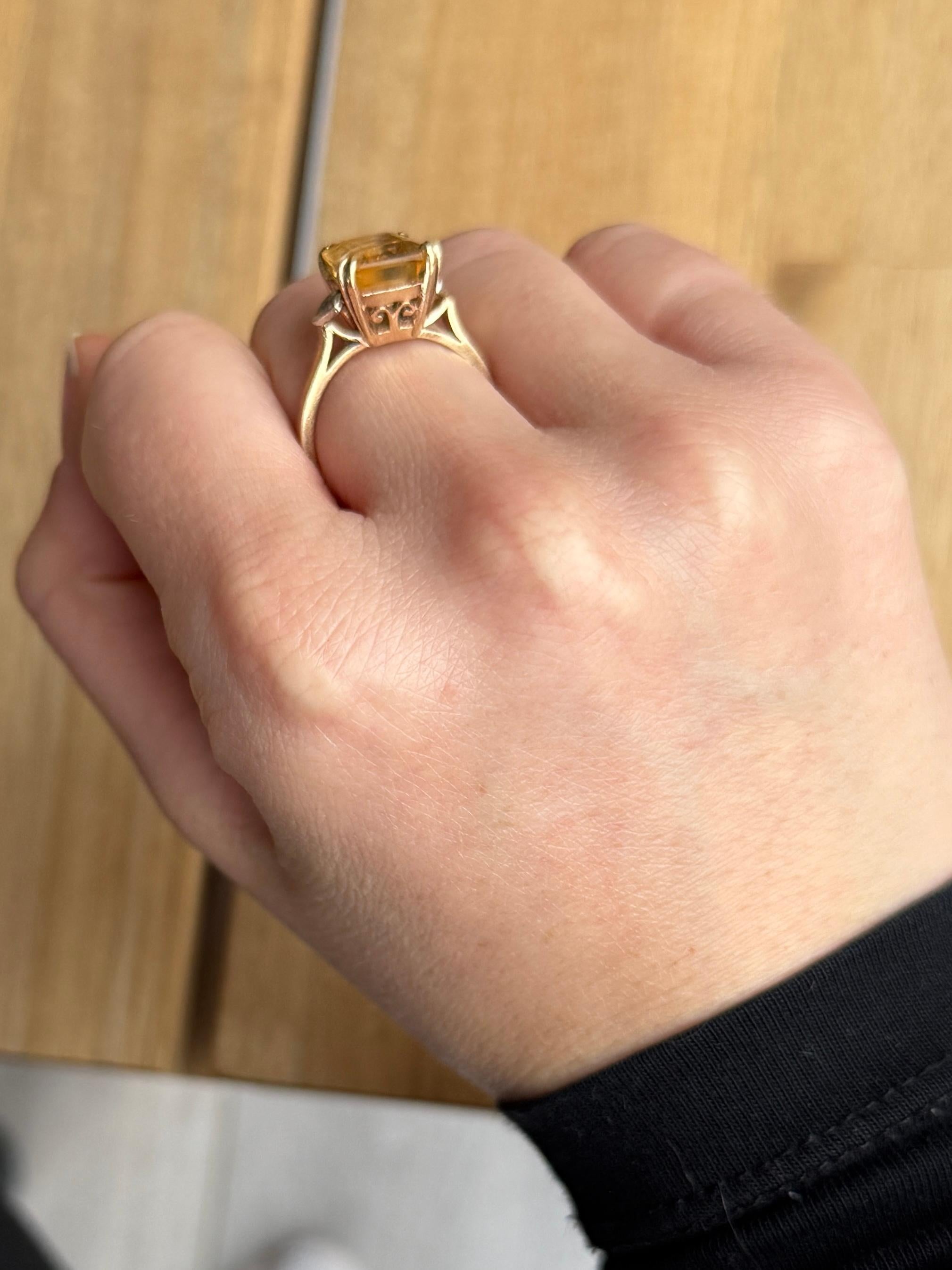 This solitaire holds an emerald cut citrine stone with diamond shoulders. The diamonds measure 3pts each. Modelled in 9carat gold. 

Ring Size: O or 7 1/4 
Height From Finger: 10mm 

Weight: 4.6g