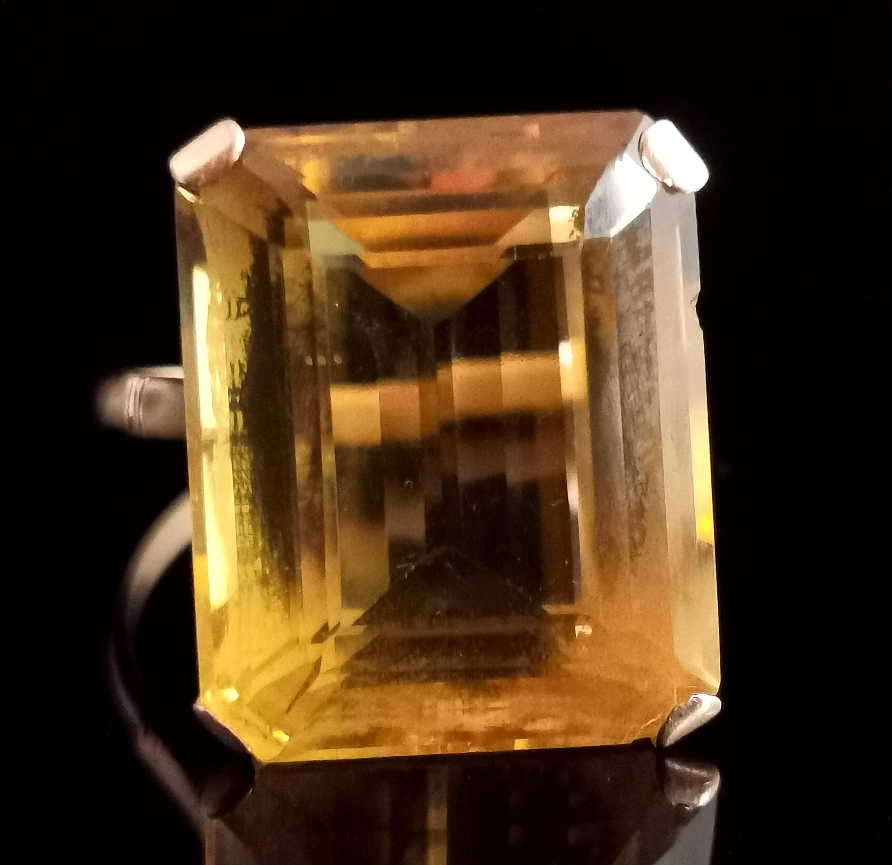 A wow vintage cocktail ring.

This ring is all about the huge citrine stone.

It is a large emerald cut, rich and warm yellow citrine, lightly stepped edges provide a subtle glisten in the light.

It is a real statement piece with a huge presence