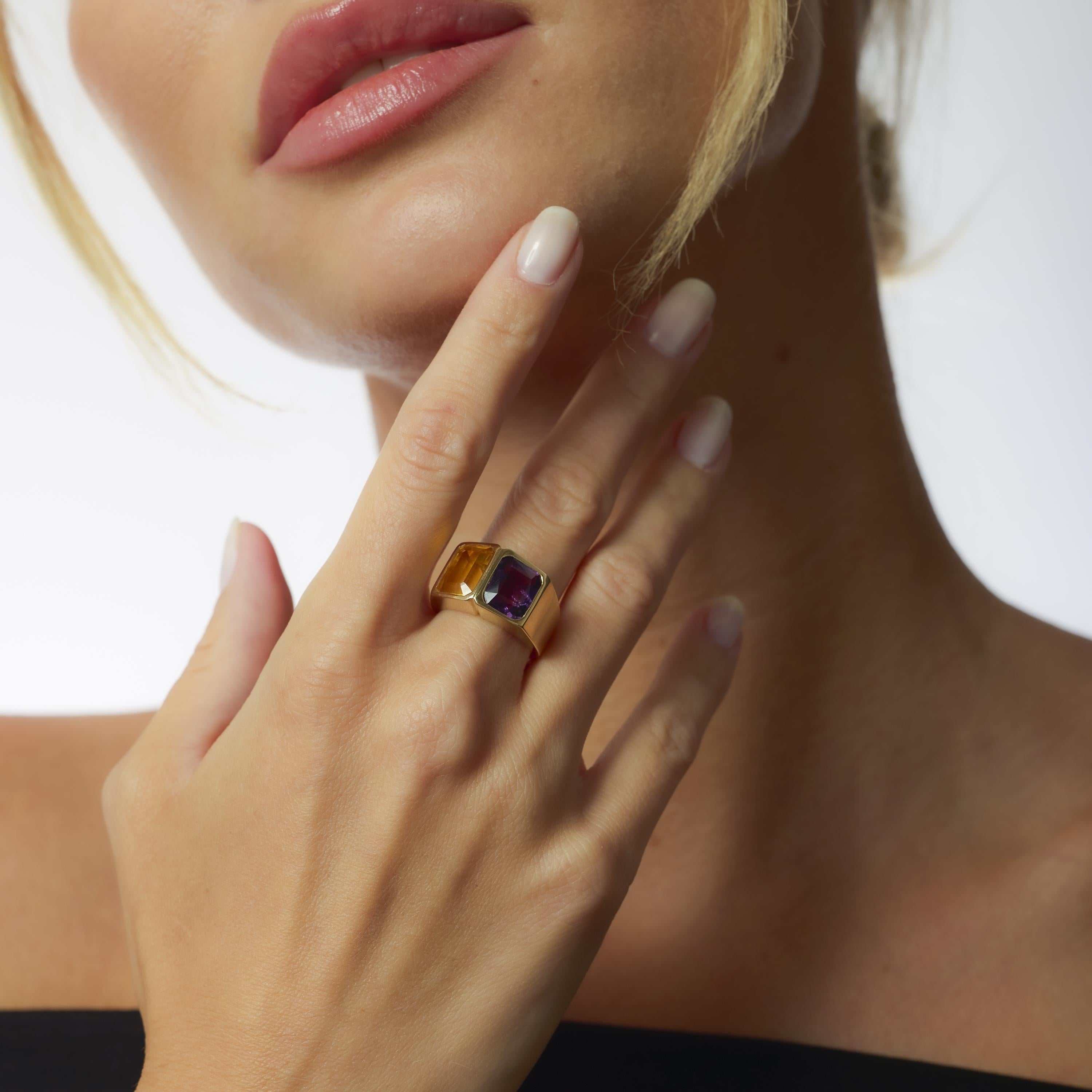 This vintage Bellarri ring in 14k yellow gold features a bold 3.40 carat citrine and a 2.55 carat amethyst in a striking geometric setting.