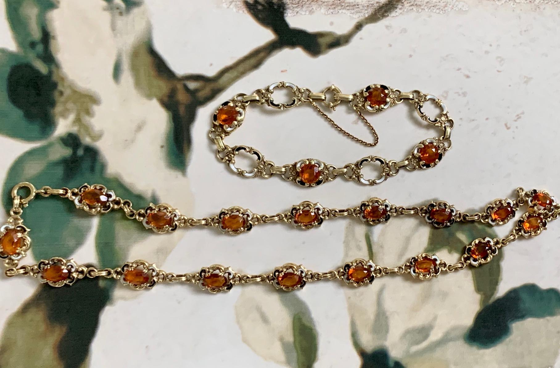 This beautiful set of vintage 14k Yellow gold Citrine necklace and bracelet feature one link of of 7 x 5mm oval faceted Citrine with white and black enameling.  

This bracelet and necklace contains one 7 x 5mm oval faceted Citrine with white and