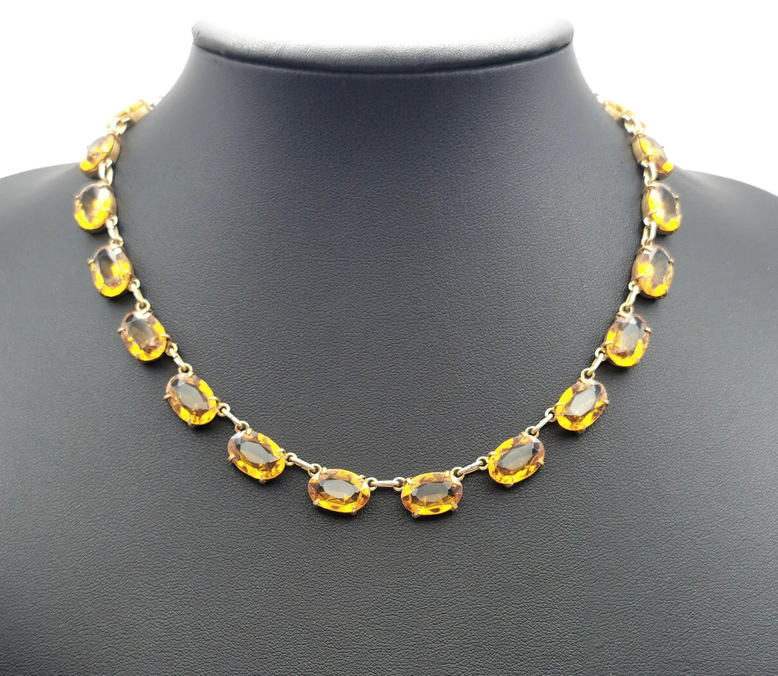 A gorgeous vintage mid century era yellow paste riviere necklace with matching earrings.

The perfect duo to add a dash of colour to your favourite little black dress.

It features rich yellow oval cut paste stones set into brass settings.

It has a