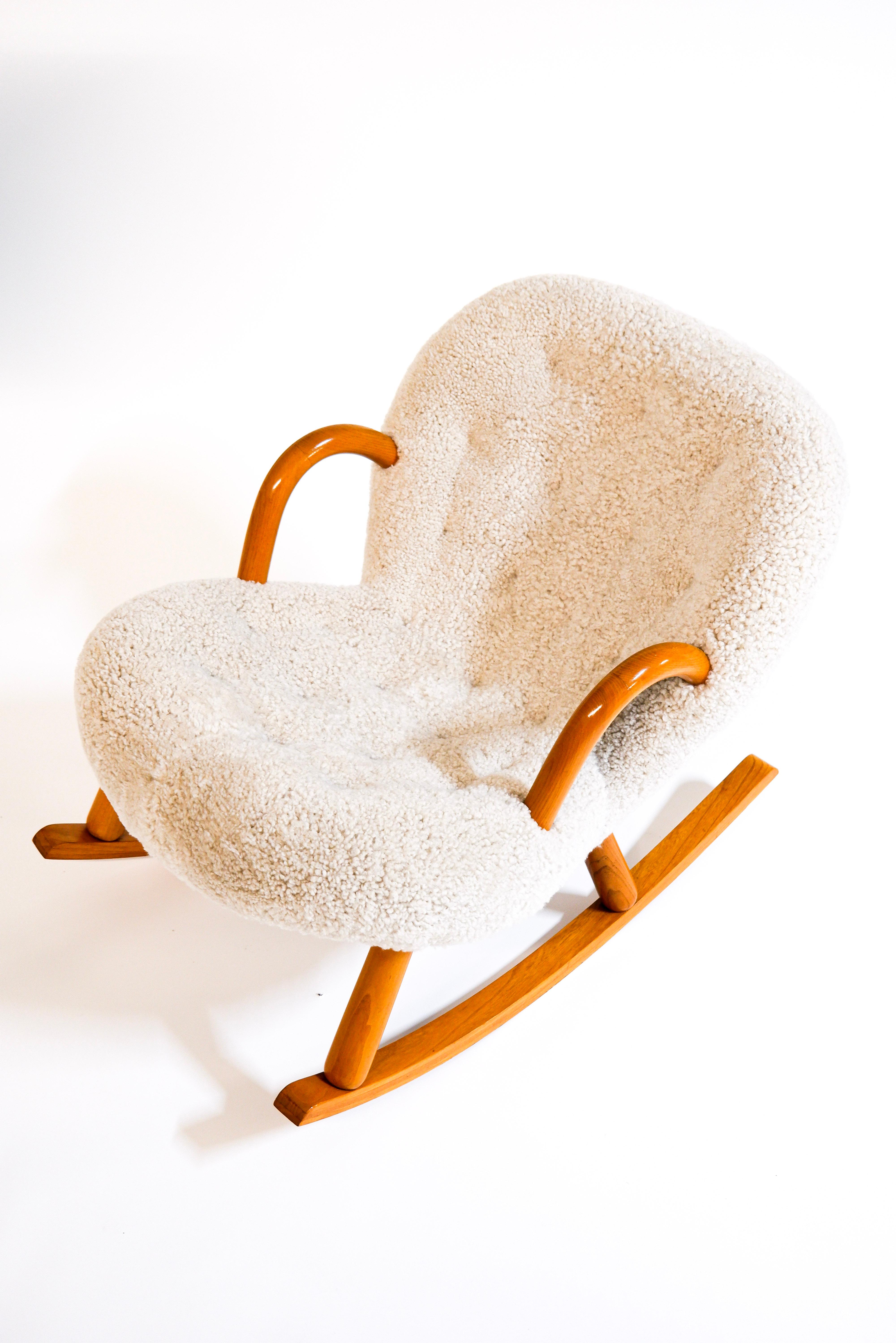 Iconic Clam chair designed by Arnold Madsen for Madsen & Schubell in Denmark in 1944. This example is a vintage original armchair produced in the 40's in danemark. The chair has been reupholstered in premium Sheepskin from New Zeland. The arm chairs