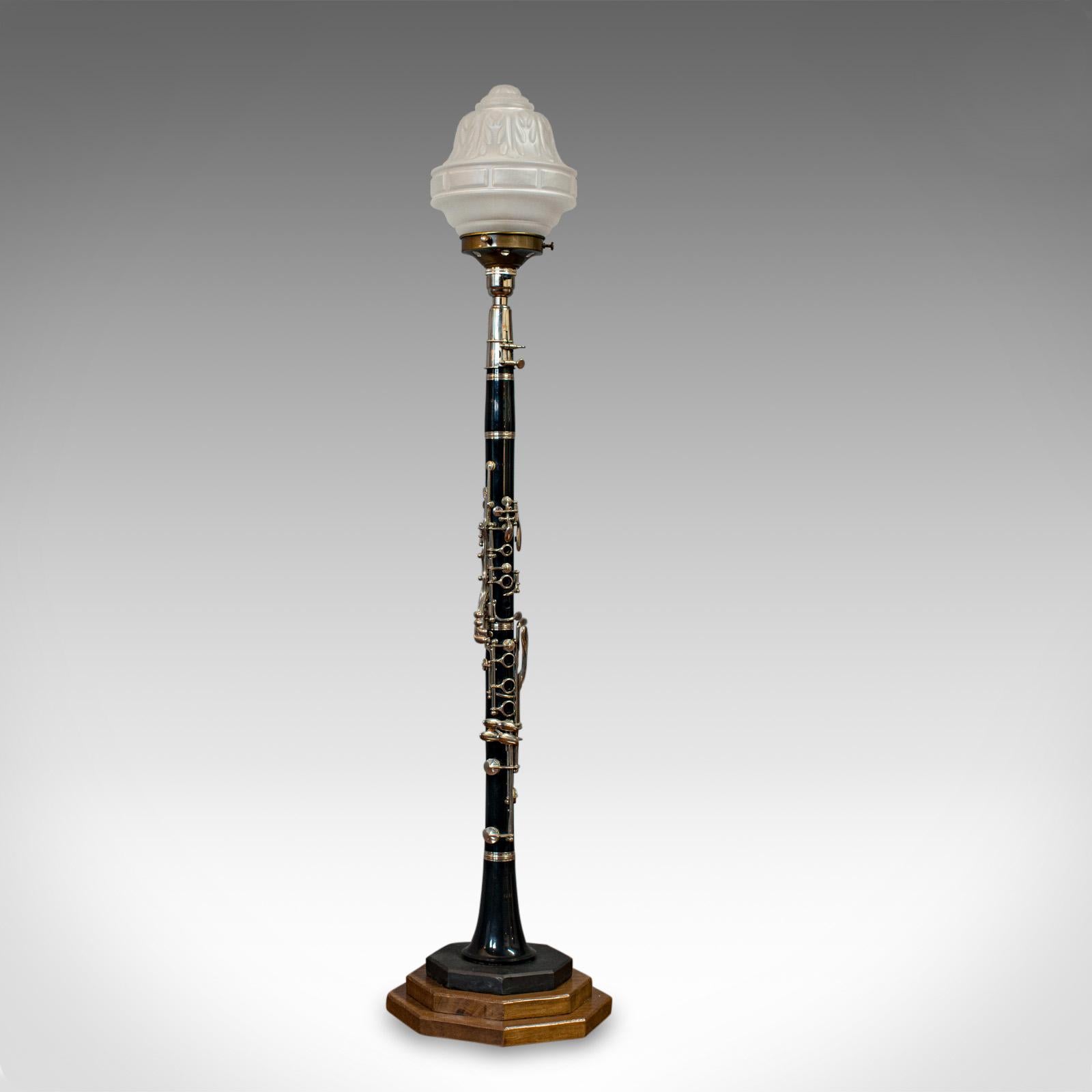 This is a vintage clarinet lamp. A bespoke, handmade table light beautifully crafted from this Classic musical instrument.

In excellent condition, fully working with quality, opaque glass shade
Attractive clarinet with working metal