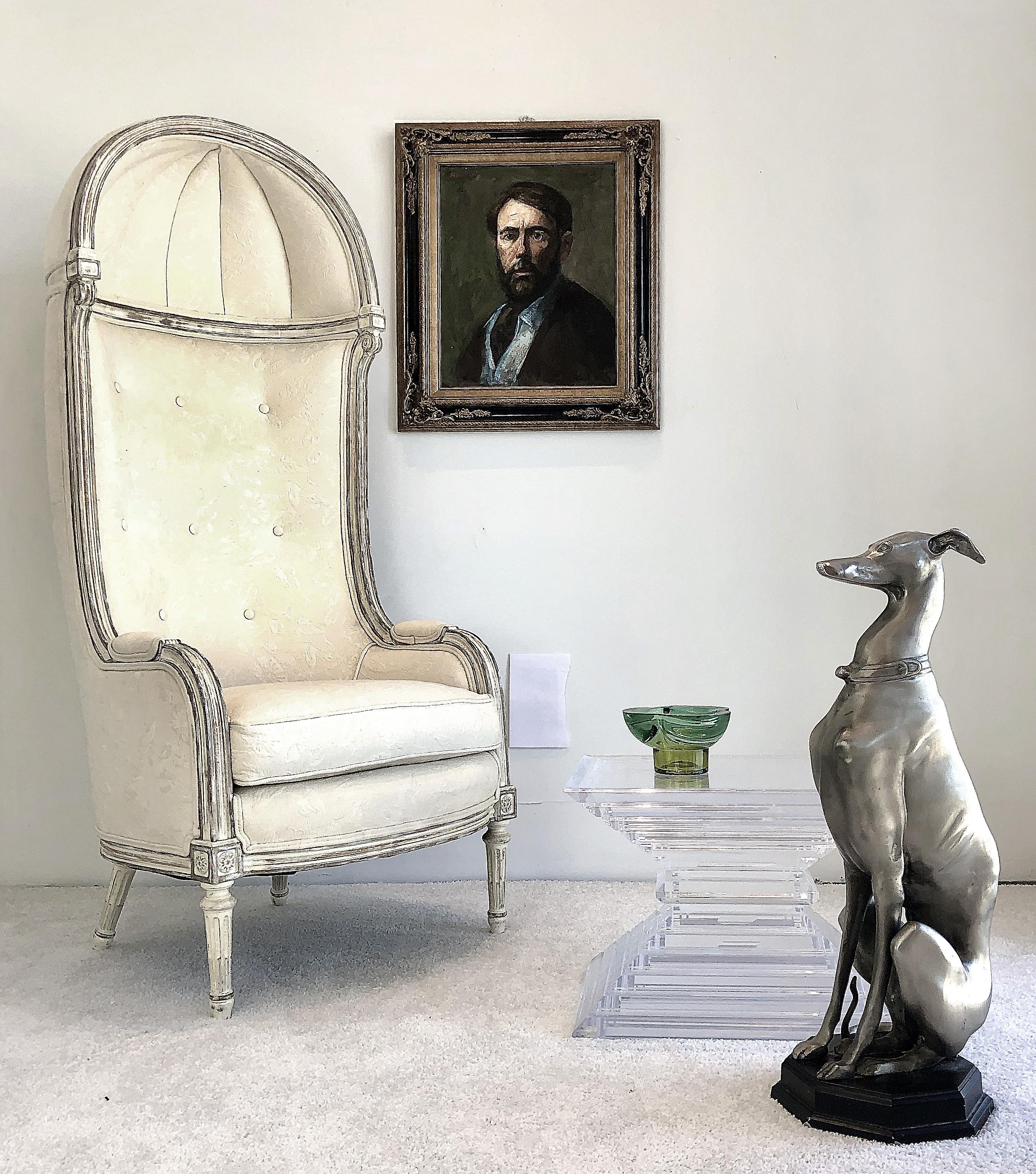 Vintage traditional hooded carved porter's chair in damask 

Offered for sale is a 1980s stately and classically styled hooded porter's chair created after Kreiss Furniture. The entire chair is covered in an elegant damask fabric upon a carved