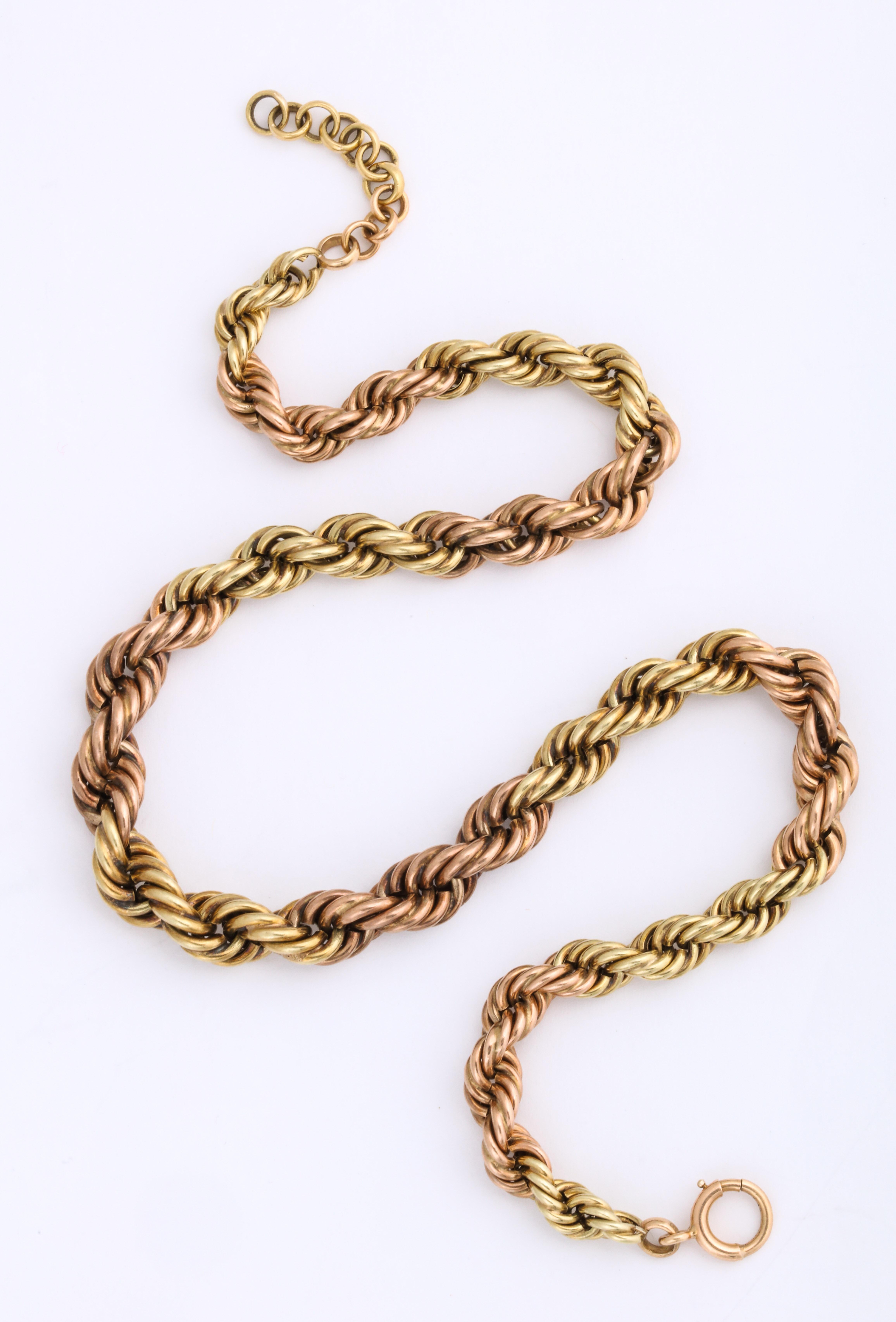 A 1940's American warm gold necklace of 14 Kt falls to the nape of the neck. It was made by the Albany New York firm of Binder and Binder. The length can be increased by adding round links next to the clasp. The necklace is made of two twisted ropes