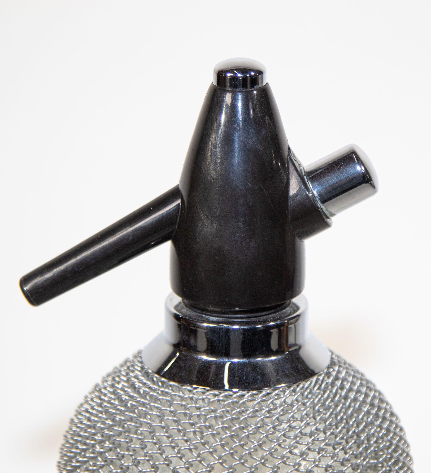 Vintage Classic Soda Siphon Seltzer Glass Bottle with Wire Mesh.
This is a fantastic vintage seltzer bottle with a metal wire mesh casing around the glass.
Vintage seltzer bottle made in Germany.
Enjoy the fresh and healthy fizz of sparkling water,