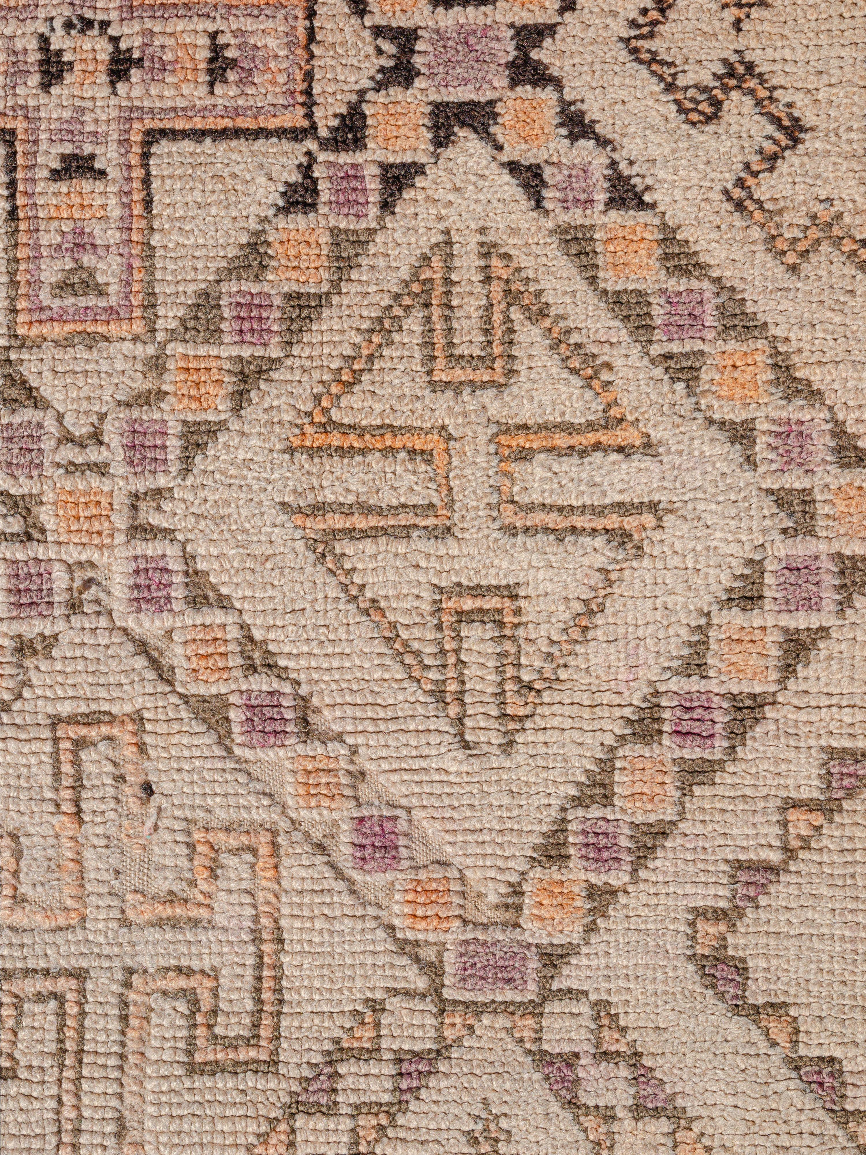 Ein verziertes Beni Ouarain im Vintage-Stil mit einem Rautennetz, das mit traditionellen und abstrakten Motiven gefüllt ist. Während einige klassische Formen leicht zu entziffern sind, sind andere schwerer zu entschlüsseln. Die Komposition ist recht