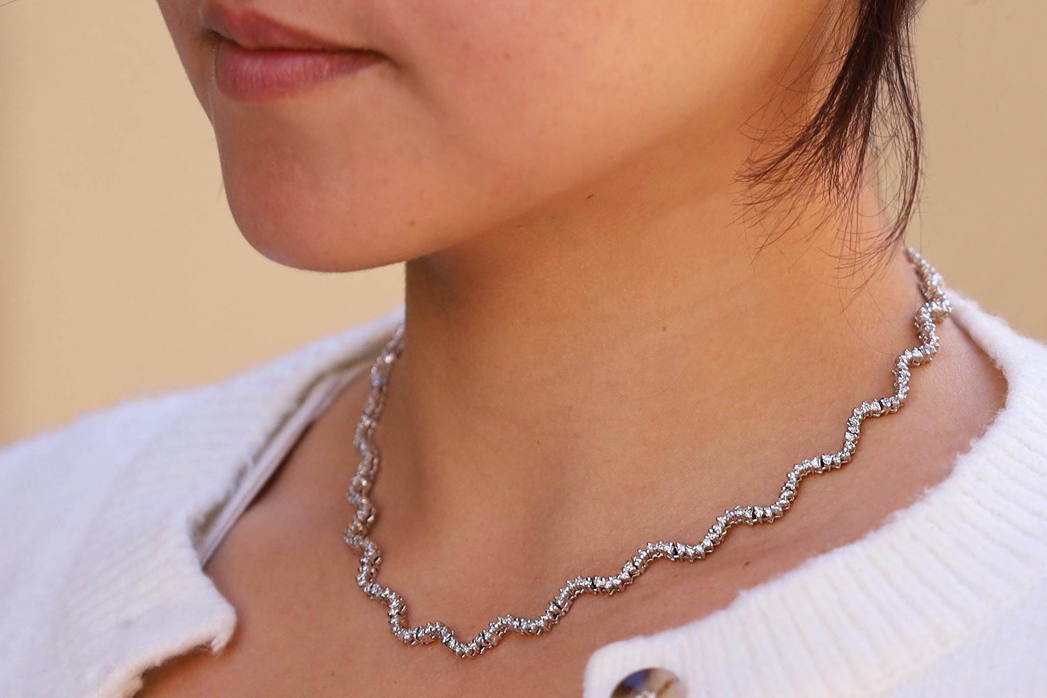 A contemporary classic, this vintage wavy tennis necklace emanates high fashion luxe. Expertly crafted in 14 karat white gold, a dazzling river of 240 diamonds adorn the entire length which totals 2 1/2 carats. Easy to style and appealing while worn