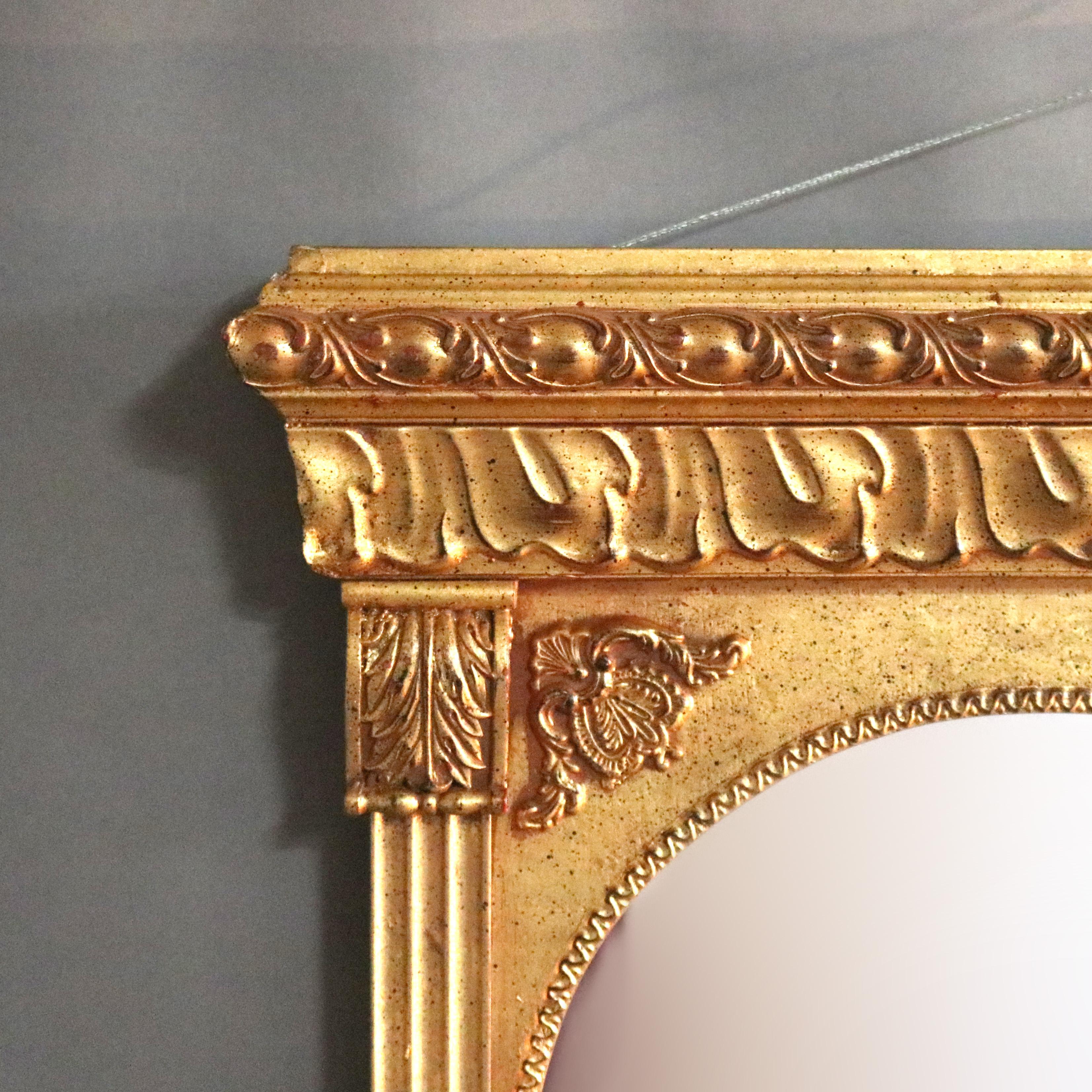 A vintage classical triptych over mantel mirror offers giltwood construction with three arched mirrors seated in reeded, foliate and acanthus decorated frame, 20th century

Measures: 36