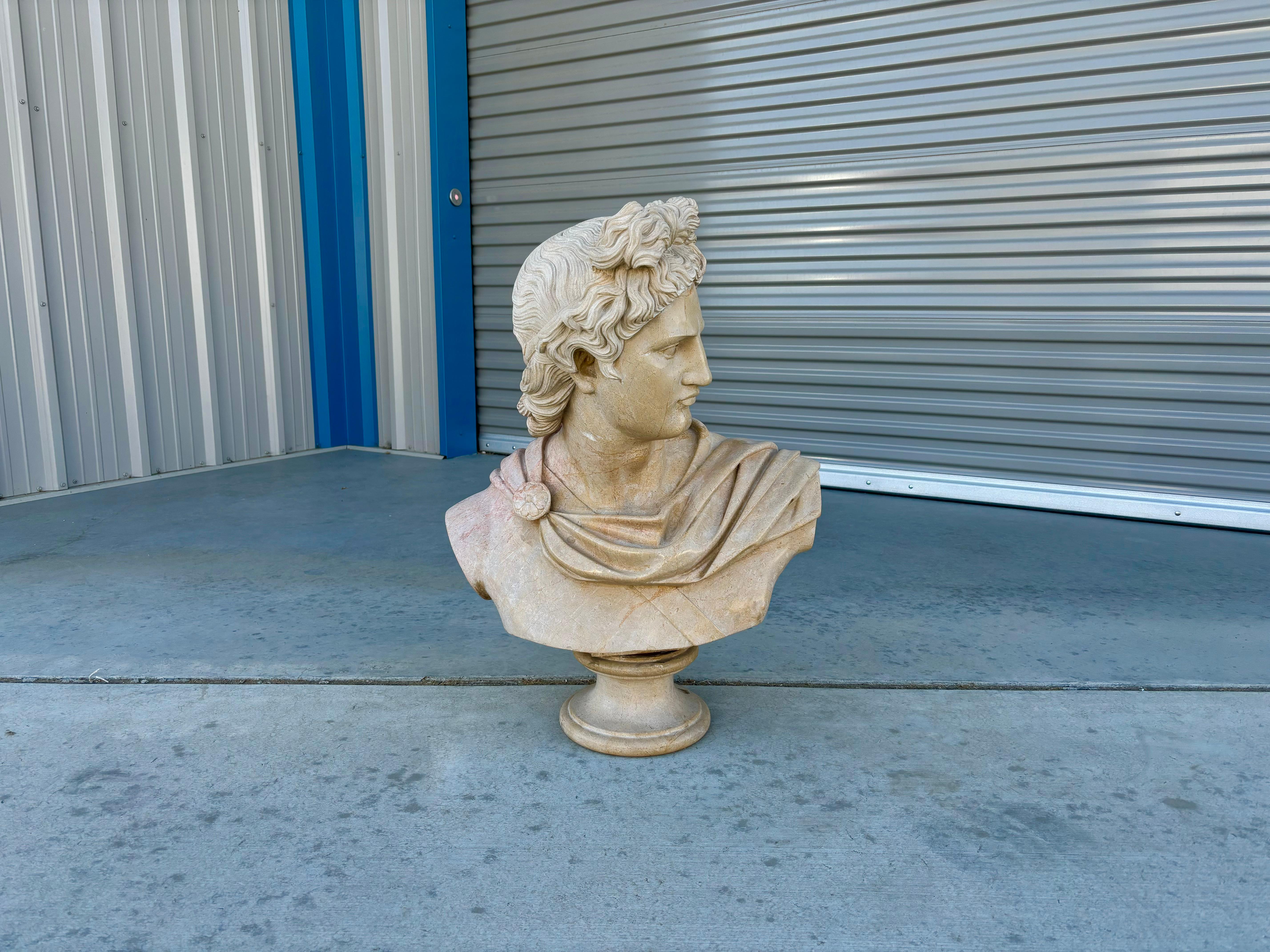 Vintage marble bust of Apollo designed and manufactured in Italy circa the 19th century. The stunning marble frame showcases the intricate details of Apollo's chiseled features, capturing the god's essence of beauty and grace. This magnificent