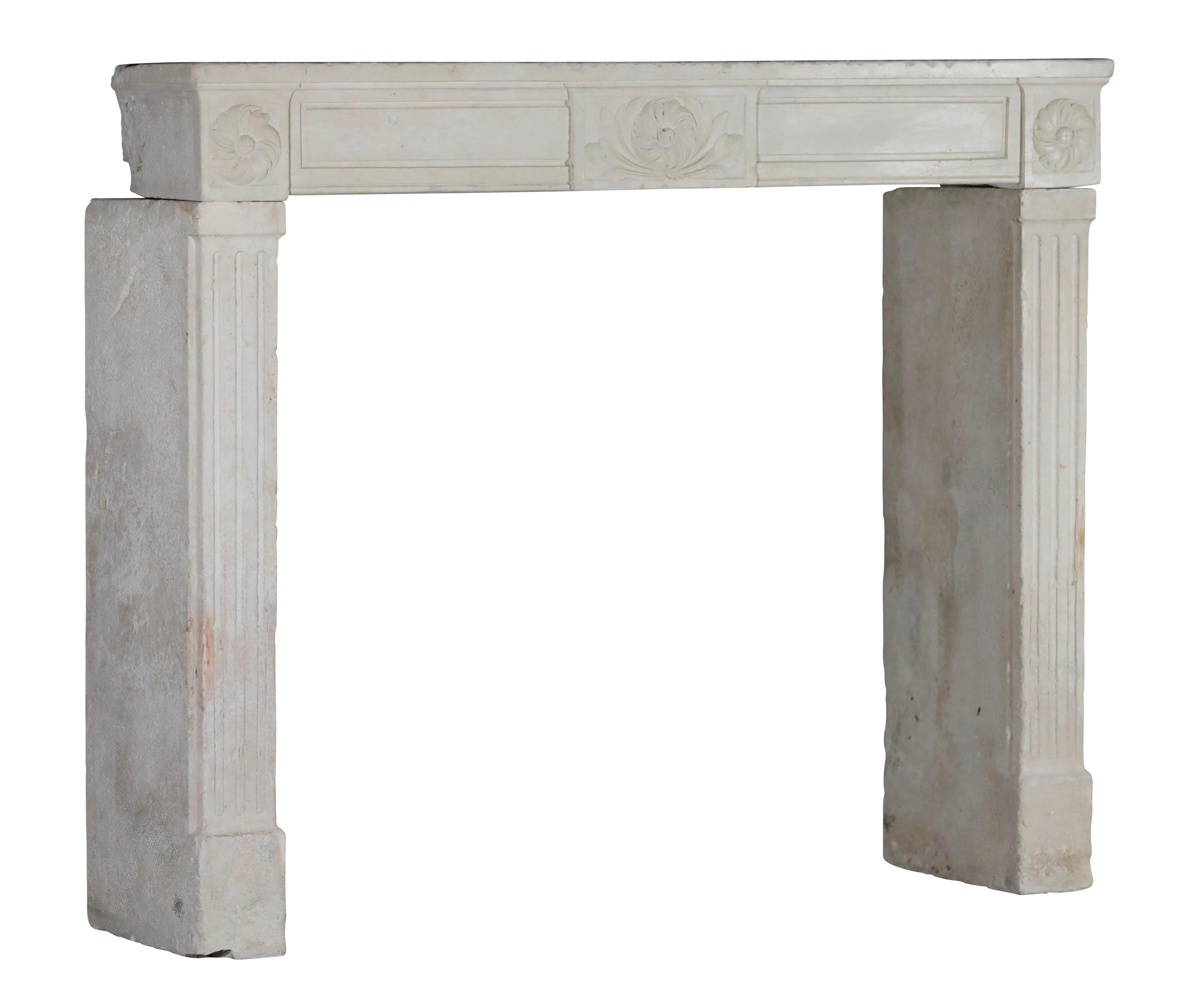 French Classic 18th century period limestone fireplace surround. This reclaimed delicate Louis XVI style fits different timeless interior design concepts. The wear on the surface comes with it as an extra. The perfect imperfection work of