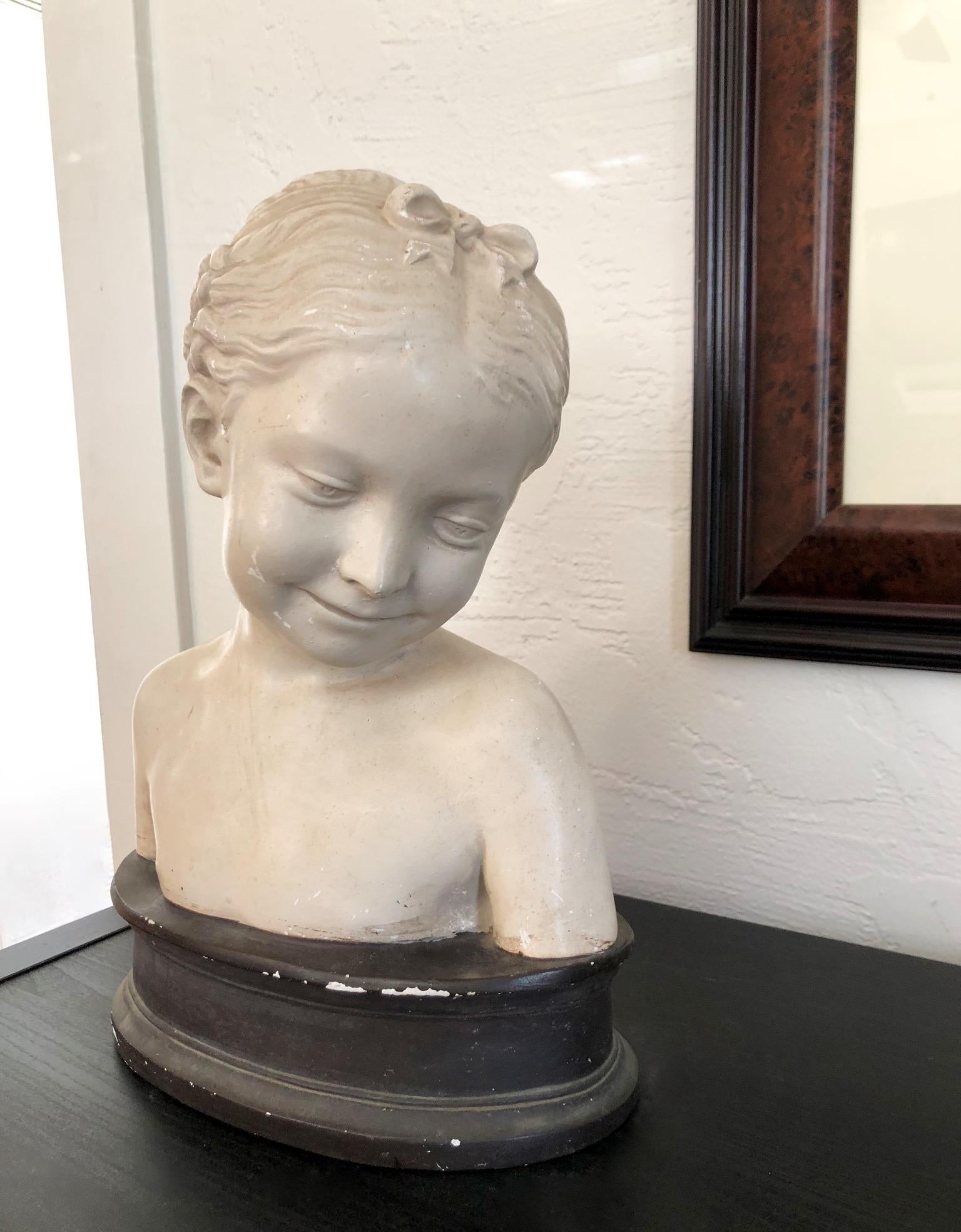 Gorgeous vintage bust of a young girl with braided hair. Age is 1920s-1940s. The bust is clay and the base is a composite wood. All signs of age and wear shown in photos. The girl is a beautiful creamy white. This piece would work perfectly as a