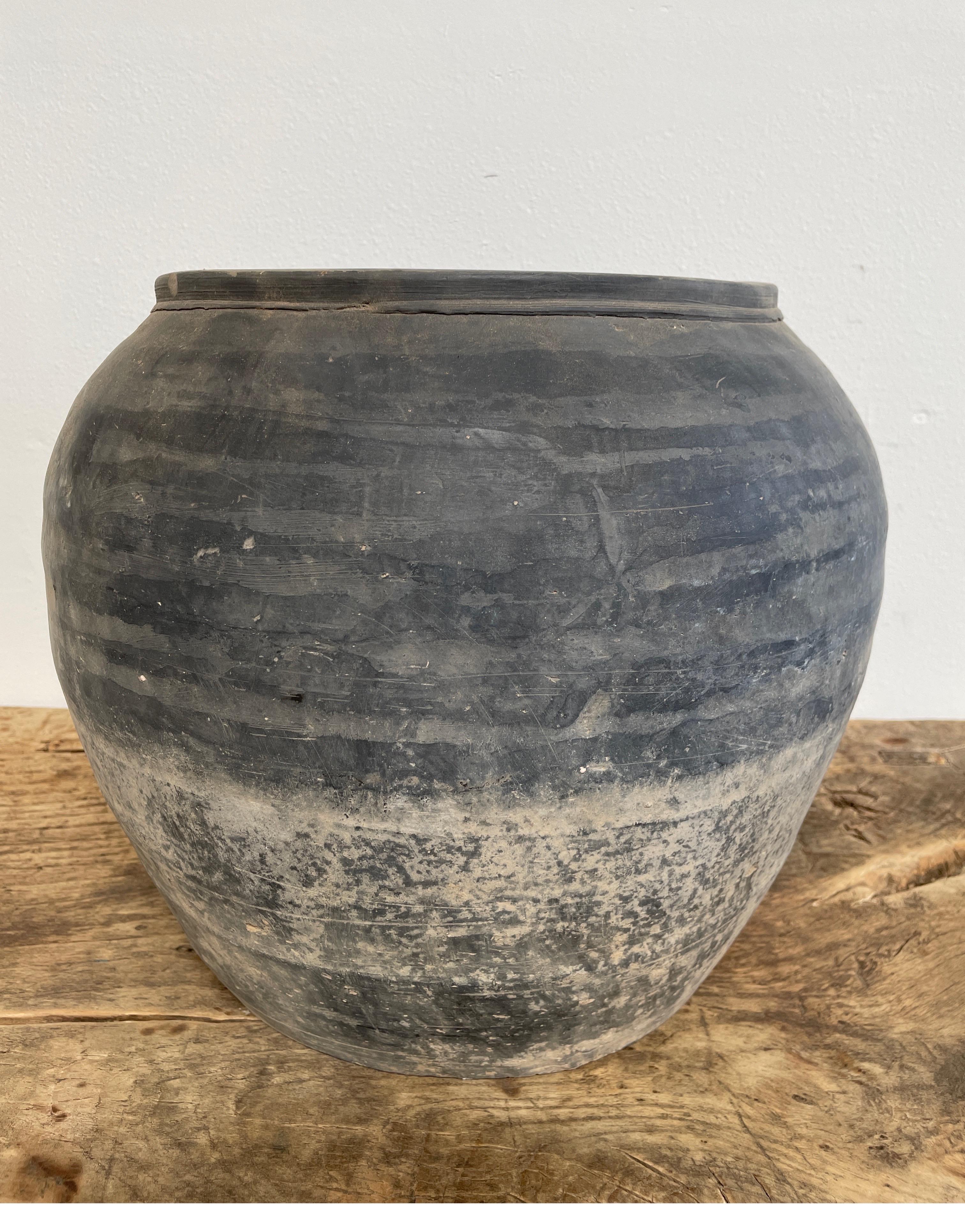 Vintage pottery

Beautiful and rich in character, this vintage oil pot adds just the right amount of texture + warmth where you need it. Stunning faded black/ brown unglazed finish with warm terra-cotta accents.
Some have a more faded appearance