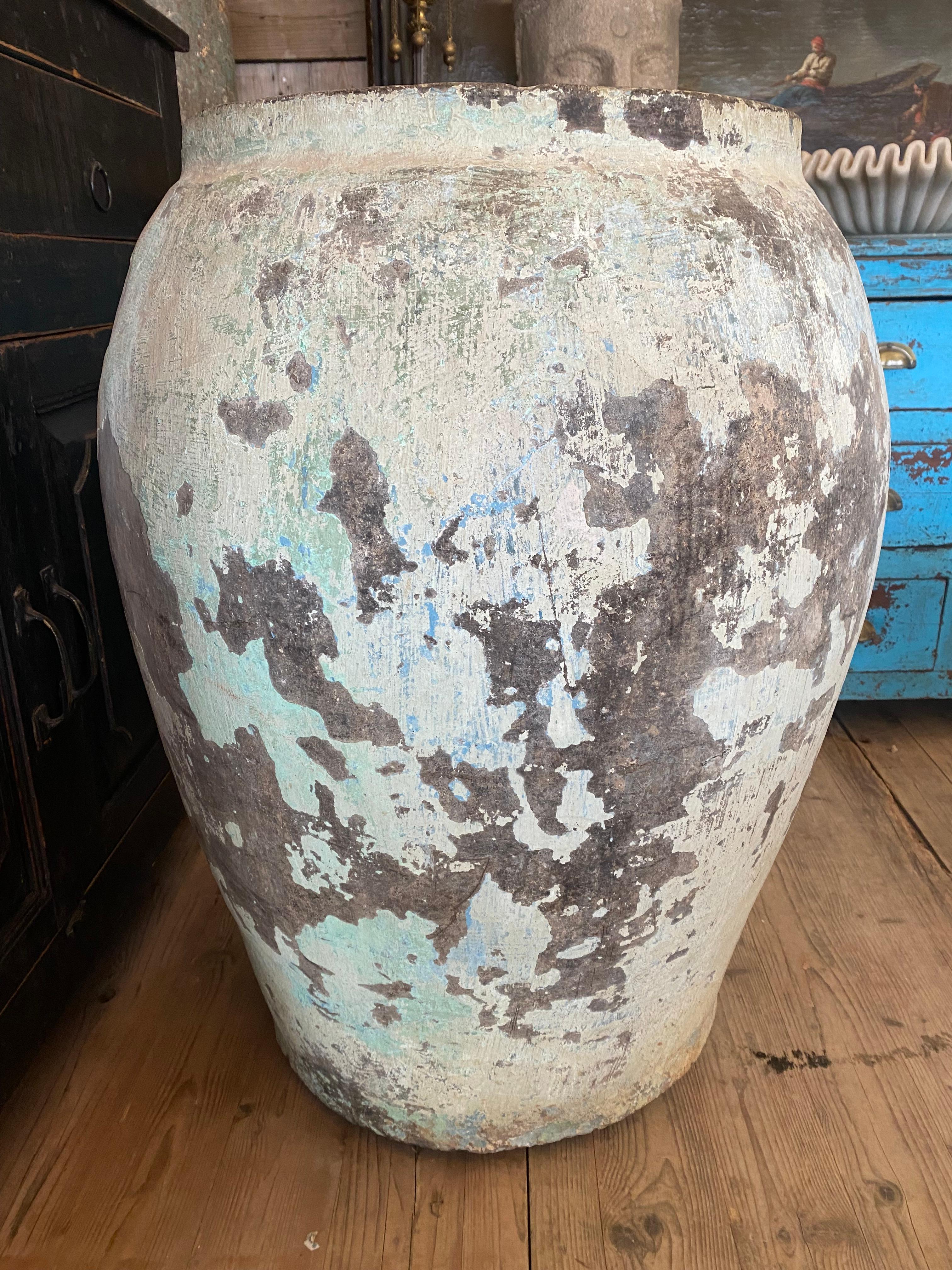 Clay pot with Nice original green patina. 
This pot was used to stock grain in Rajasthan desert.
It can stay outside if you drill it. I can make it on request