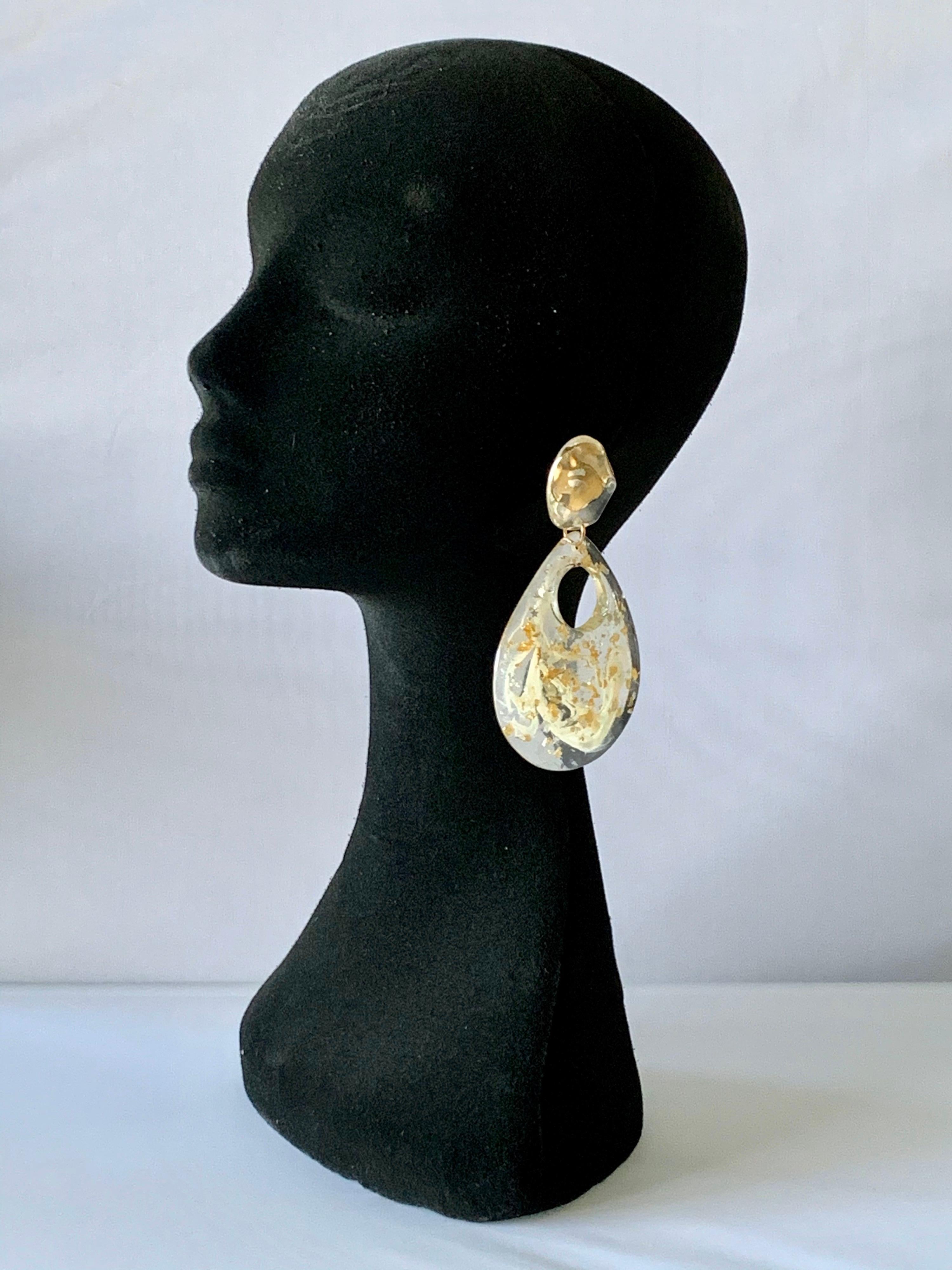 Vintage large clear acrylic gold flake, clip-on statement earrings circa 1980's/1990's. The earrings feature an edgy contemporary design, unsigned. 