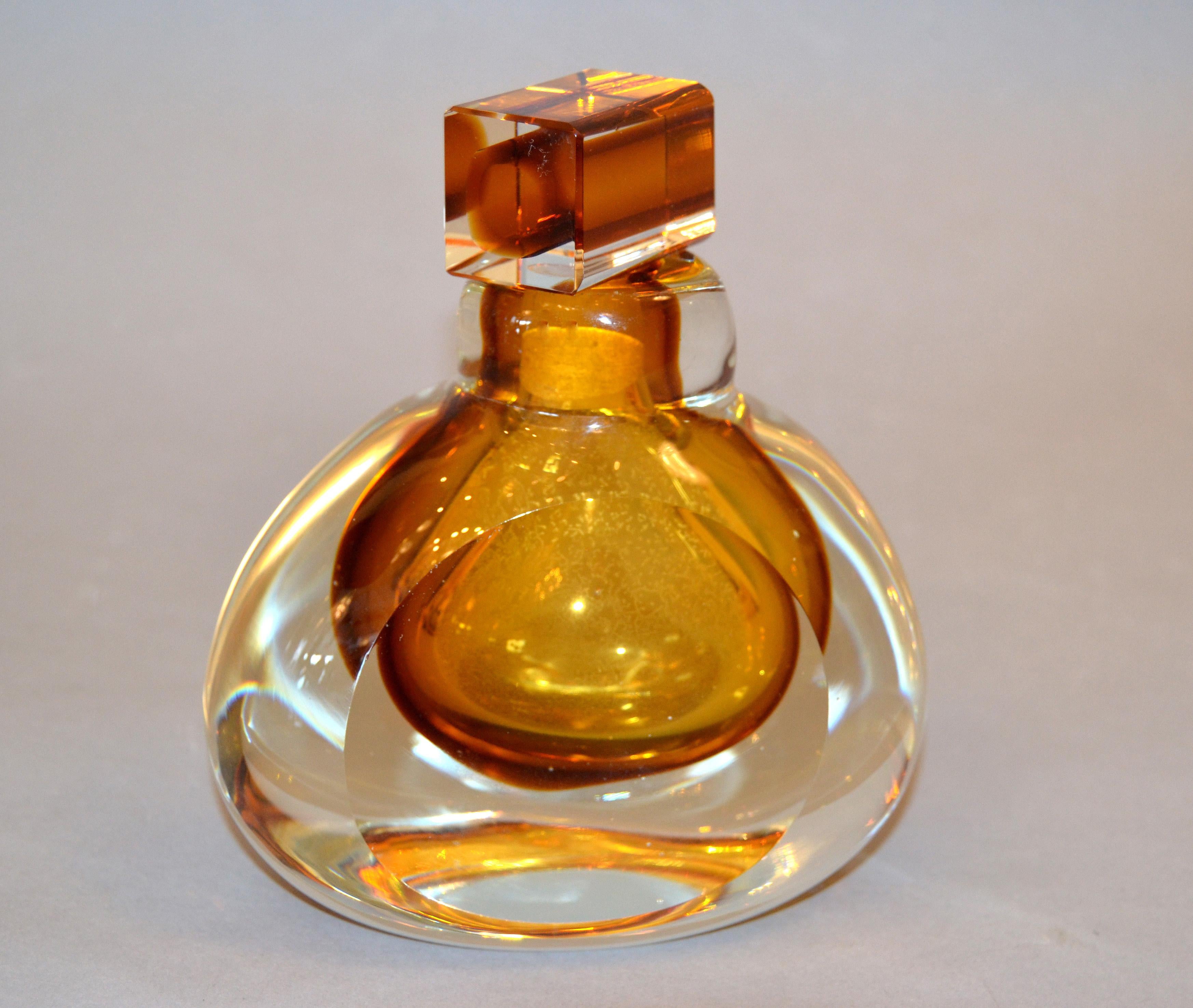 Vintage clear and amber inclusions with controlled bubbles Murano art glass perfume bottle with a stopper.
Heavy perfume flacon which looks different from each angle.
Beautiful for your Boudoir. 
  