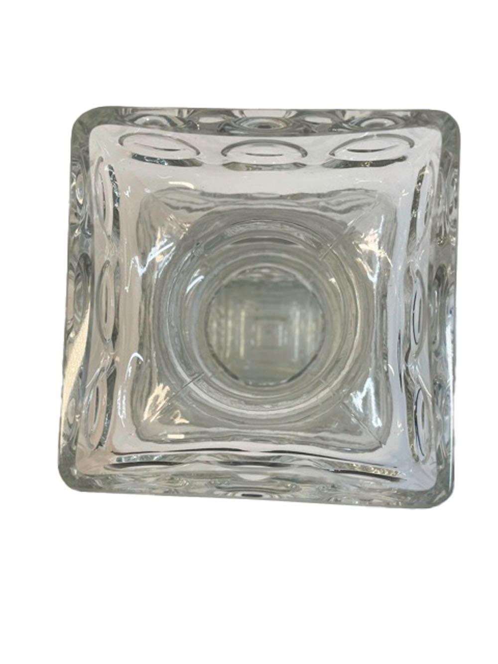 Mid-Century Modern Riihimaki clear glass vase of square form with textured surface, the top molded with 2 waisted bands separating a squared collar and rim each molded with 3 raised rings to each side.