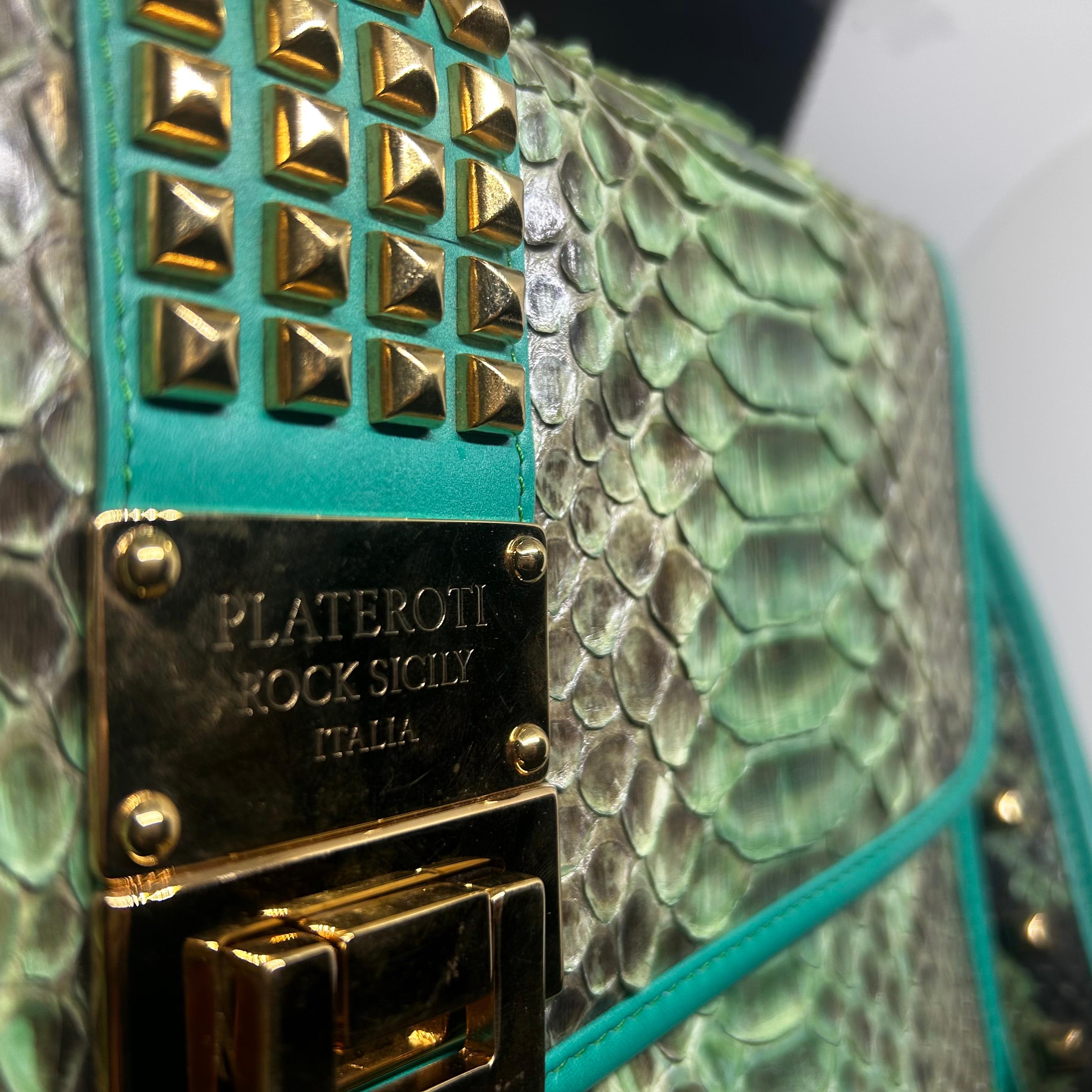 This stunning clutch by Clementina Plateroti is an exquisite example of luxury craftsmanship, showcasing the beauty of genuine python skin. The scales feature a mesmerizing gradient of soft green and ivory tones, giving the bag a unique, iridescent