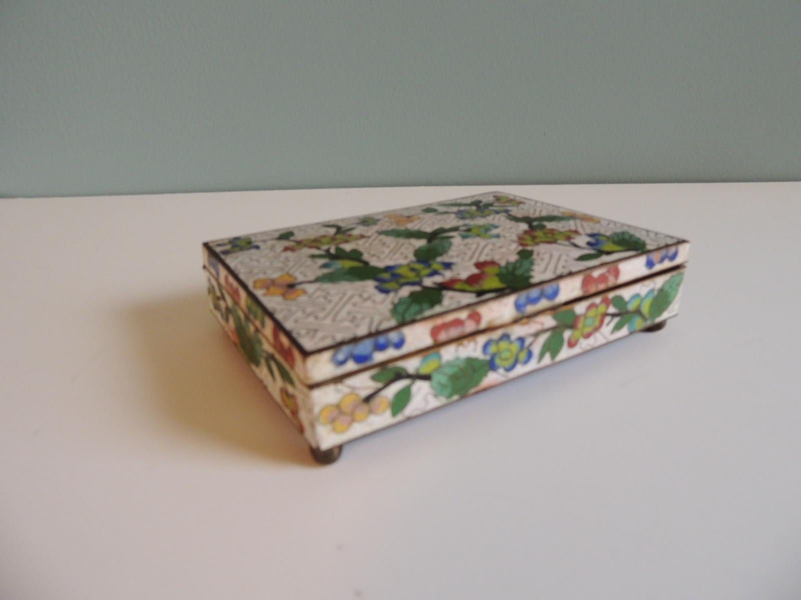 Vintage Cloisonné brass and enamel decorative footed box depicting flowers and meandering borders
Cobalt blue enamel inside compartments.
Size: 6 x 4.5 x 1.5.