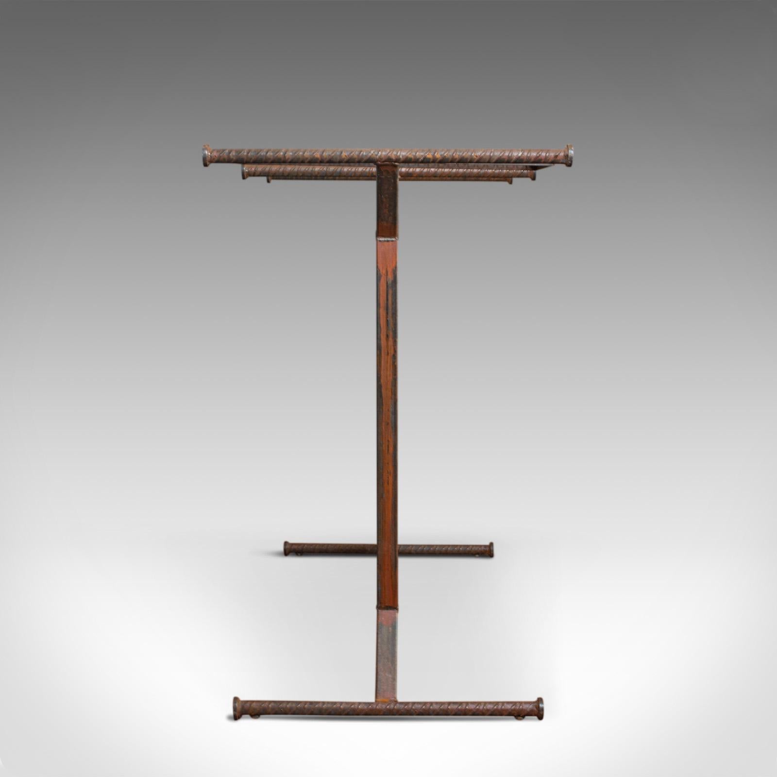 This is a vintage clothes rail. An English steel and oak retail shopfitting in industrial taste and dating to the 20th century.

Desirably aged steel and oak with fine grain interest
Strong industrial taste with coloration and dark staining
A
