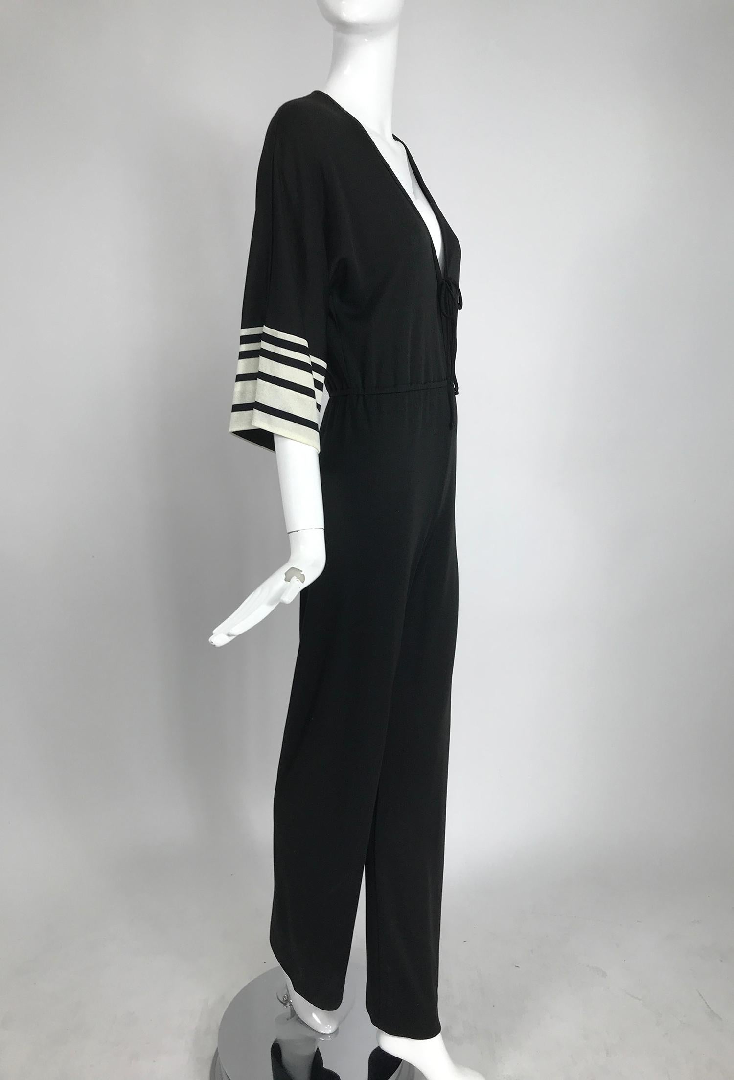 Vintage Clovis Ruffin Ruffinwear, black and white jersey jumpsuit from the 1970s. Sleek black jersey jumpsuit with a plunge neckline, ties at the front, cased elastic waist and long full legs. The sleeves are full and elbow length with narrow and