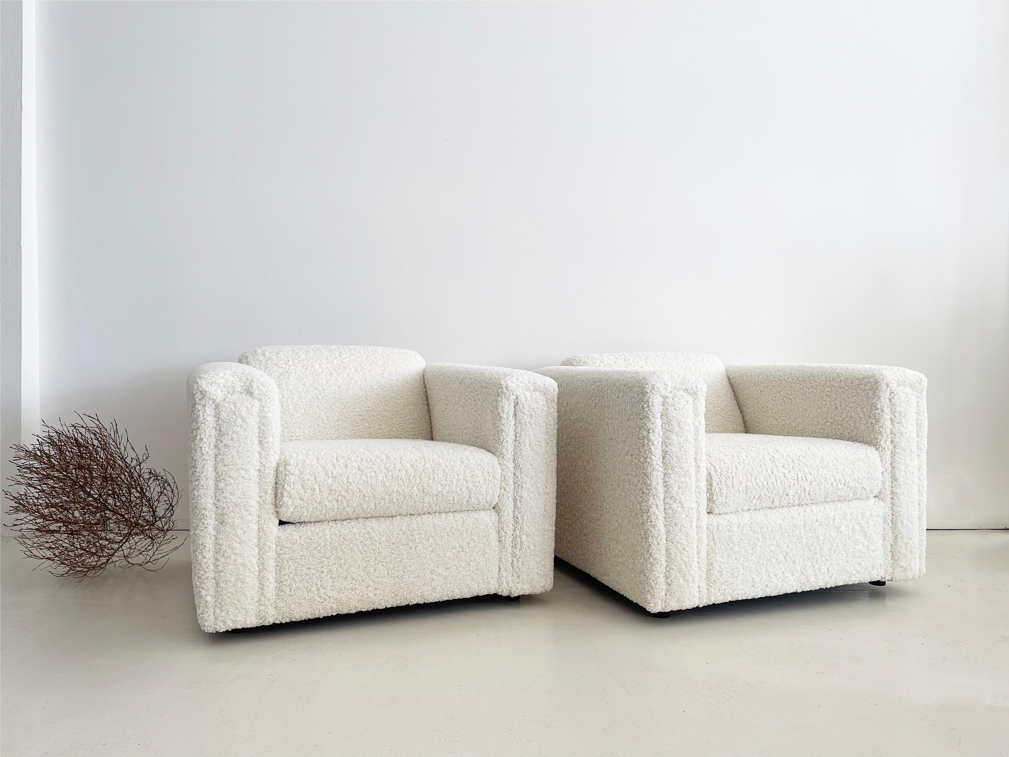 Set of two large, unmarked vintage armchairs newly reupholstered by MENO in Kravet Faux Sheepskin: Almost White.

This set is an original pair, sourced together.

Excellent frame construction. 

Hidden 2” tall bun feet. 

No added flame