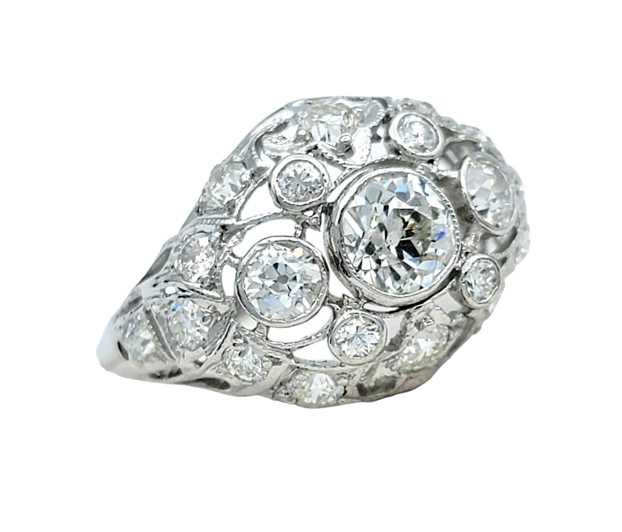Ring Size: 5

This stunning vintage diamond cluster dome ring, elegantly set in gleaming 14 karat white gold, is a timeless testament to sophistication and style. Its distinctive dome-shaped design features a dazzling array of diamonds meticulously