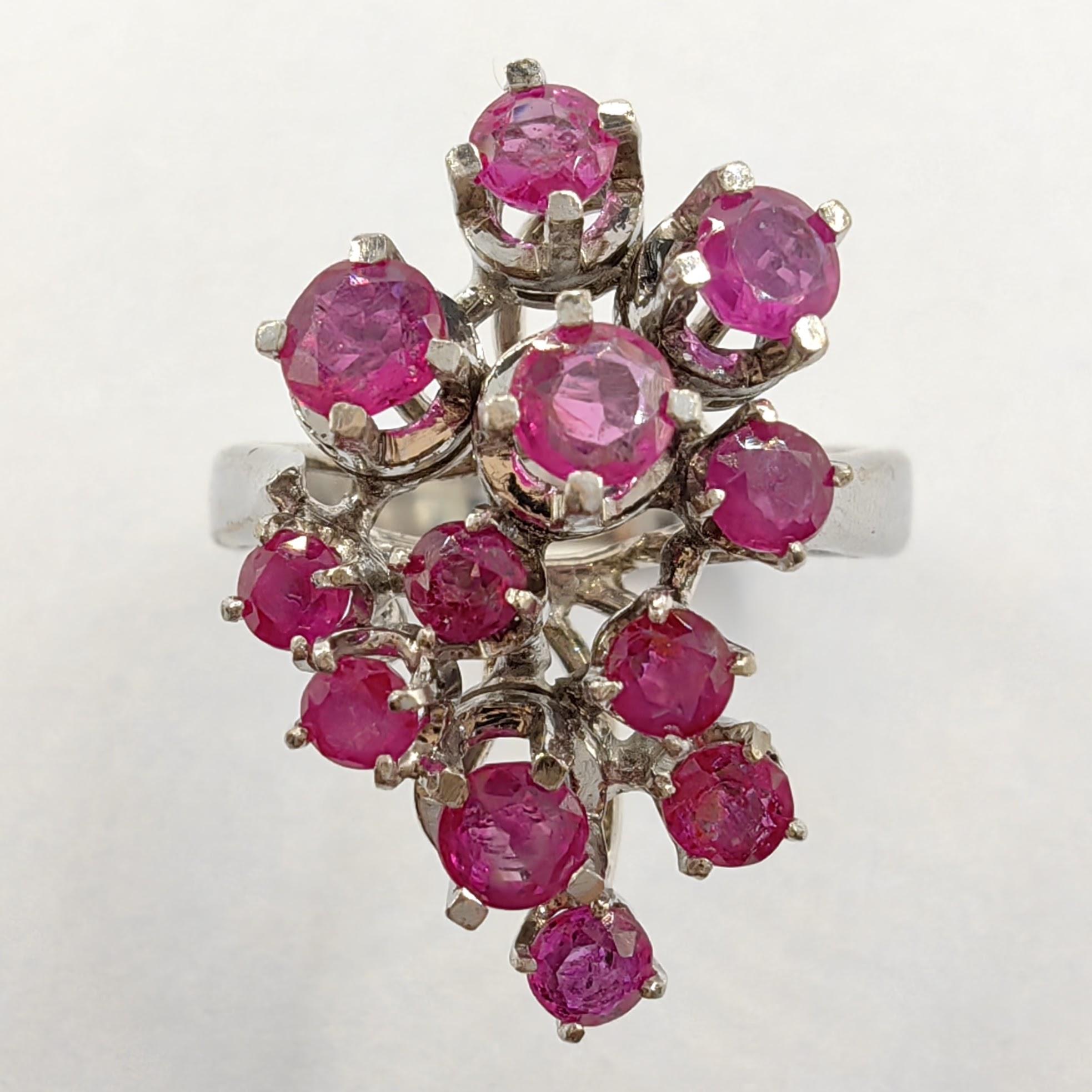 Introducing our extravagant Vintage Cluster Ruby Ring in White Gold, a true statement piece that exudes boldness and flair. This captivating ring showcases an elaborate design, featuring a cluster of sparkling rubies that creates a visually striking