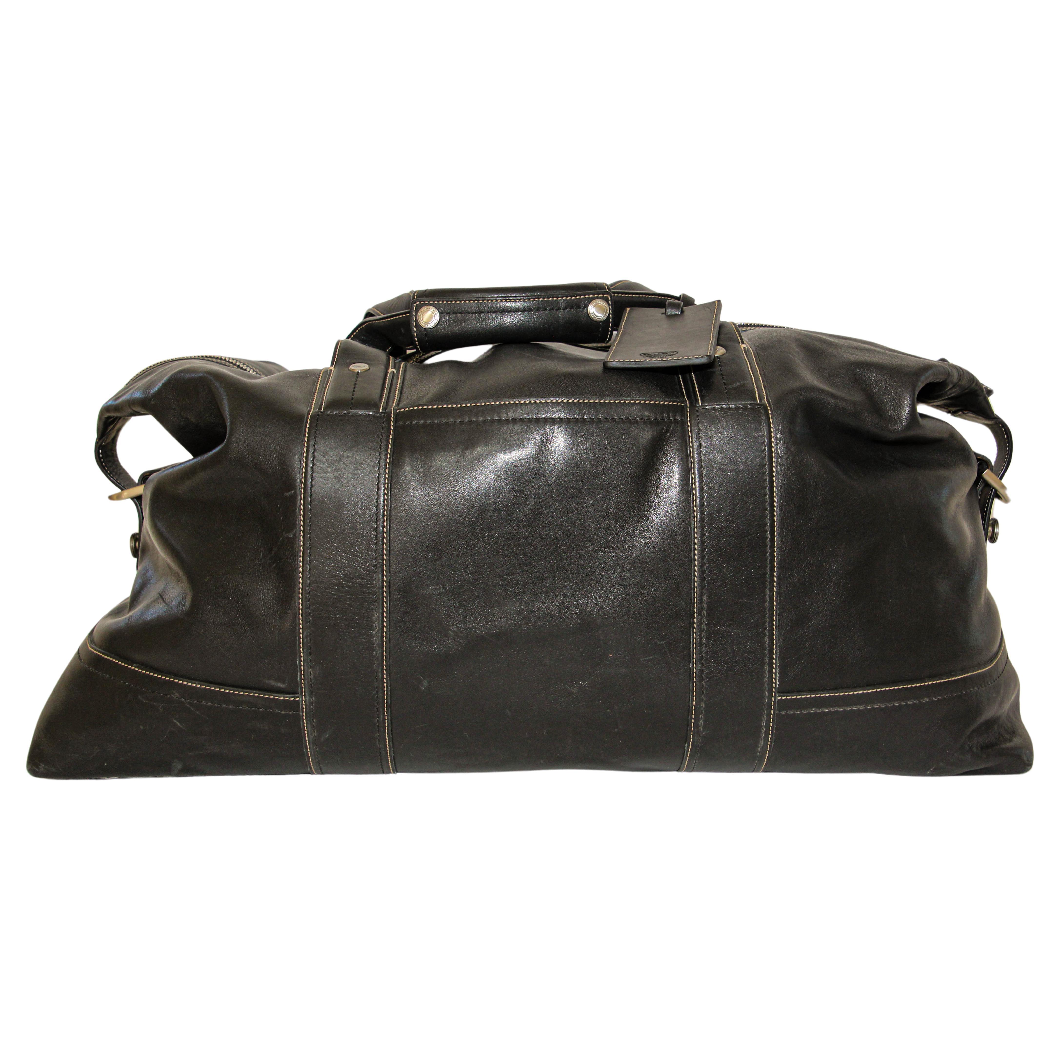 Coach Vintage Black Leather Men's Carry all Travel Duffle Bag.
Explore sophistication and convenience with this large Vintage Coach Black Leather Travel Bag. Crafted from premium black leather, this high-quality travel companion exudes durability