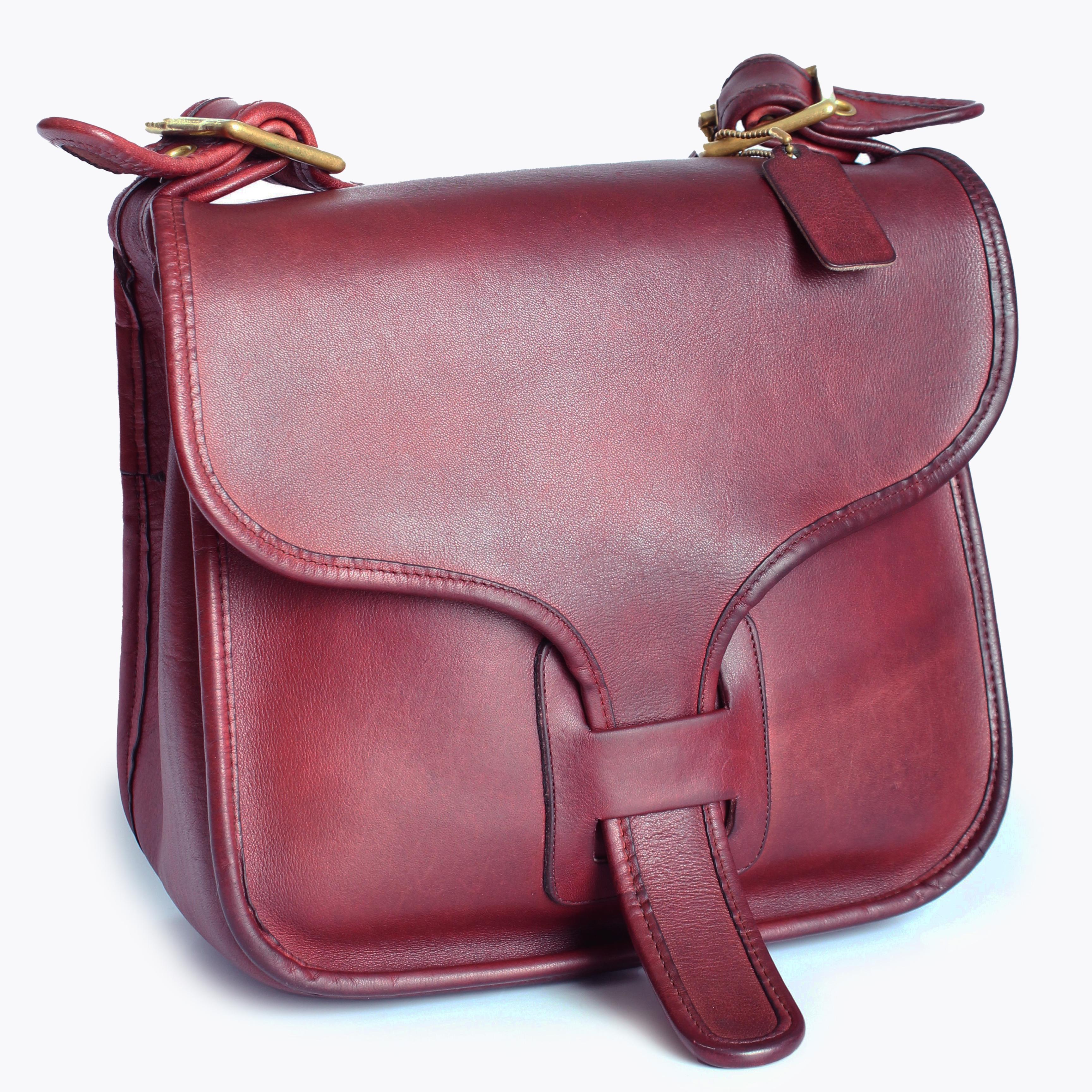 Preowned, vintage Coach Courier Bag aka the Chunky Shoulder bag, originally designed by Bonnie Cashin and made in the 1970s.  Made from patina'd burgundy leather, it features a classic top flap with tongue and the inside is unlined with one zippered