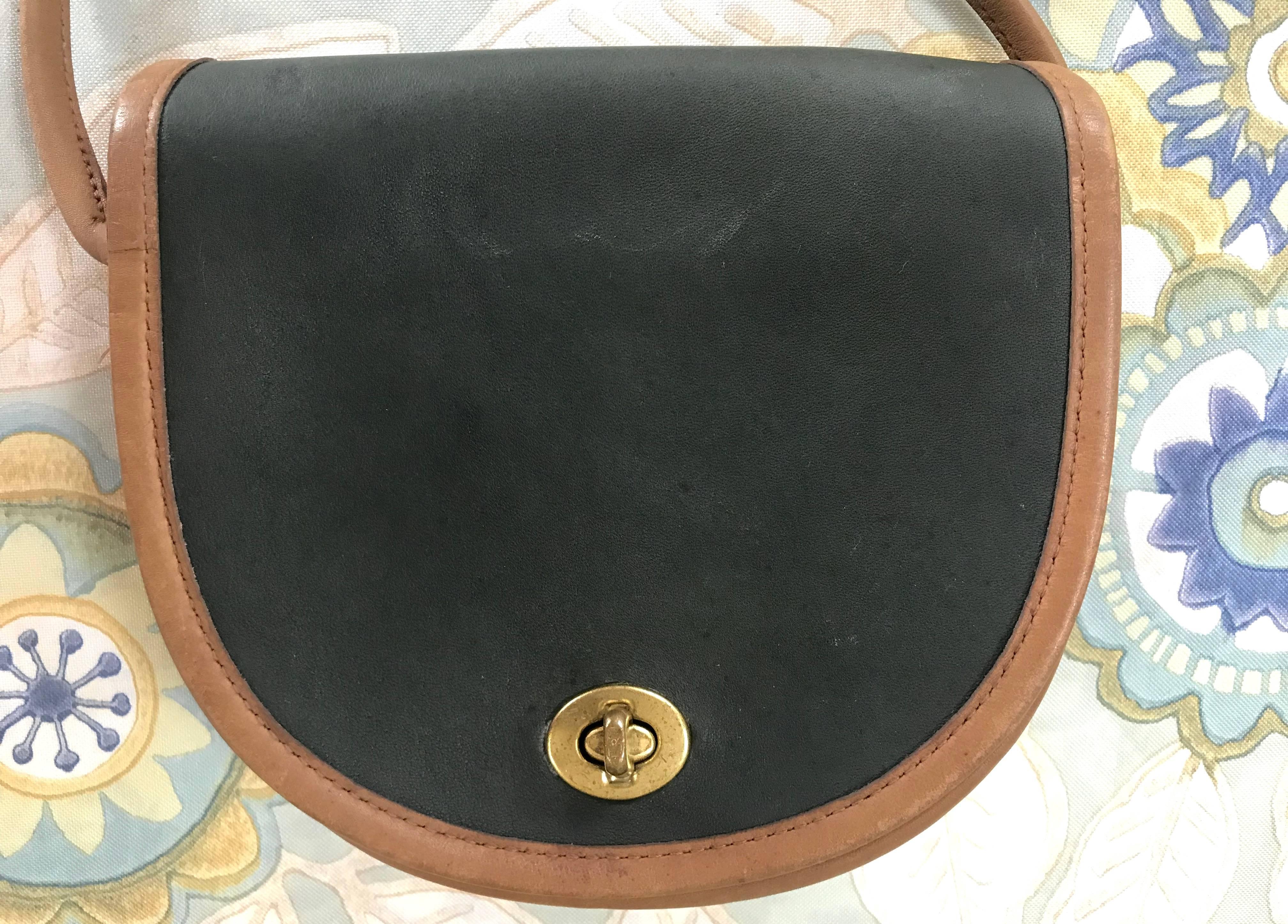 1990s. Vintage COACH genuine khaki and brown leather mini shoulder bag in half moon shape. Classic purse. Made in USA. 

Rare Coach bag in khaki and brown color combination!

This is a vintage piece of COACH in the 90’s. 
Genuine leather and cute