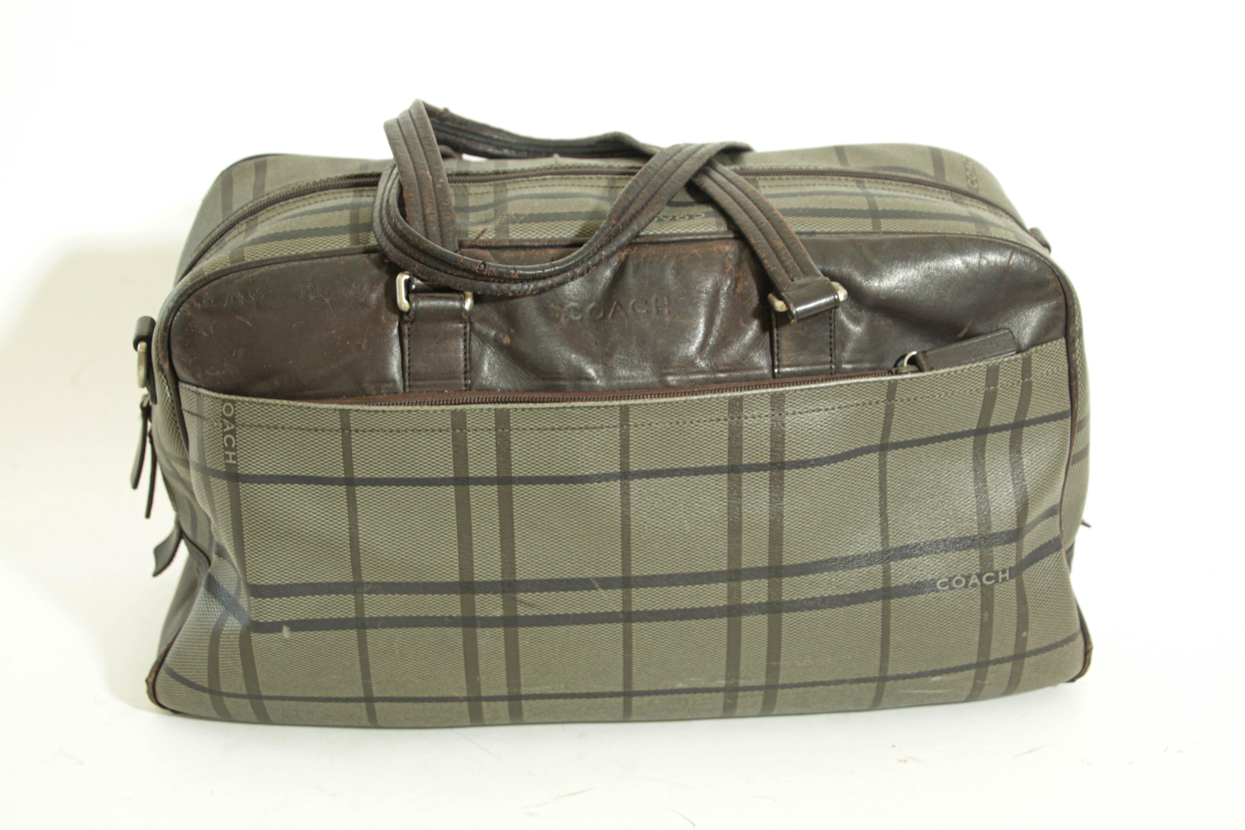 COACH grey brown and black TATTERSALL luggage duffle weekender carry-on.
Coach classic vintage canvas and leather men's carryall travel duffle bag.
Grey, brown and black Tattersall plaid canvas with brown leather trim.  
Zipper closure, silvertone