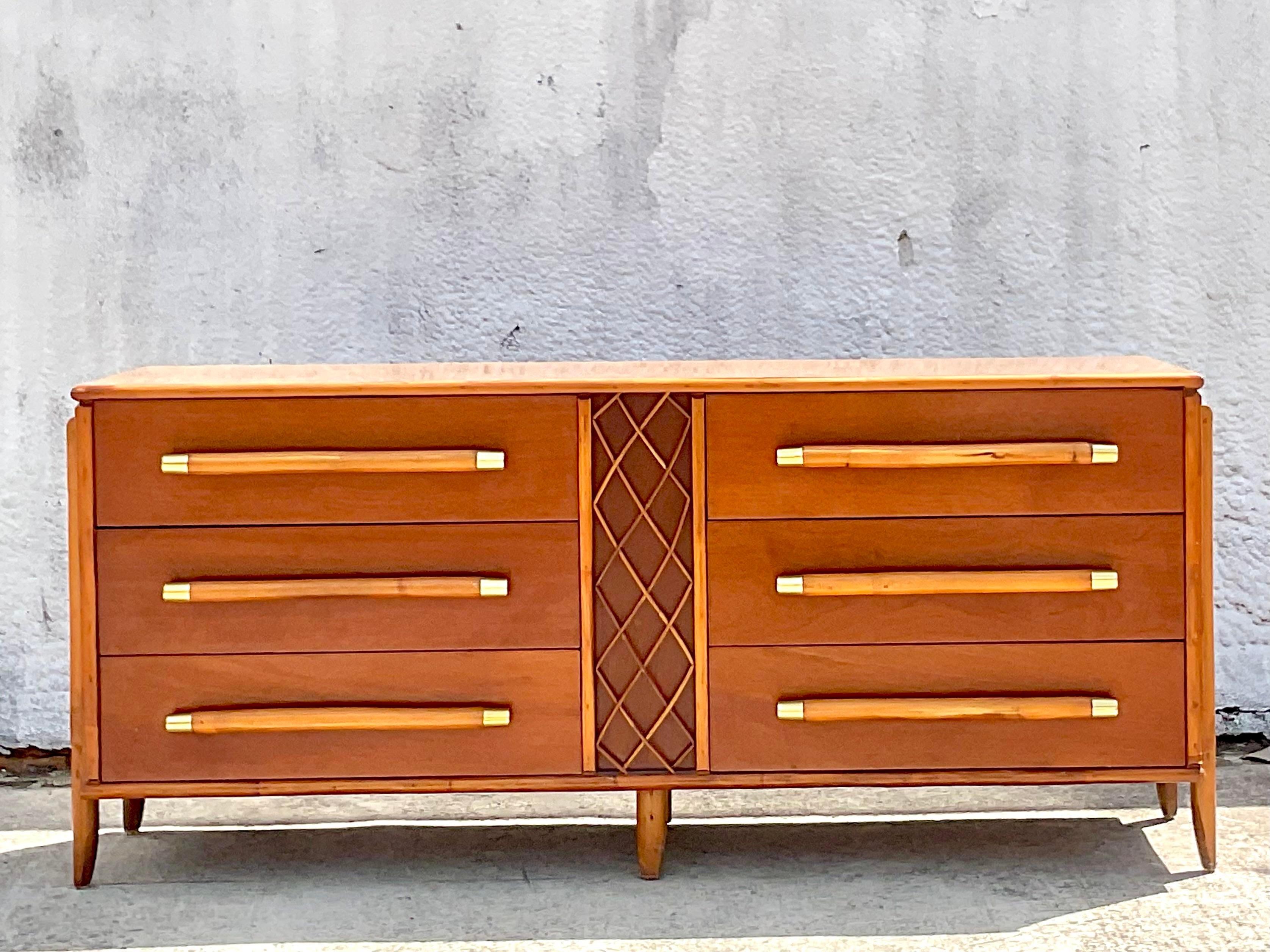 A stunning vintage Coastal credenza. Beautiful Mahogany cabinet with rattan drawer pulls with chic brass cap detail. Trellis rattan panels on each end. Laminate top for extra durability. Acquired from a Palm Beach estate.