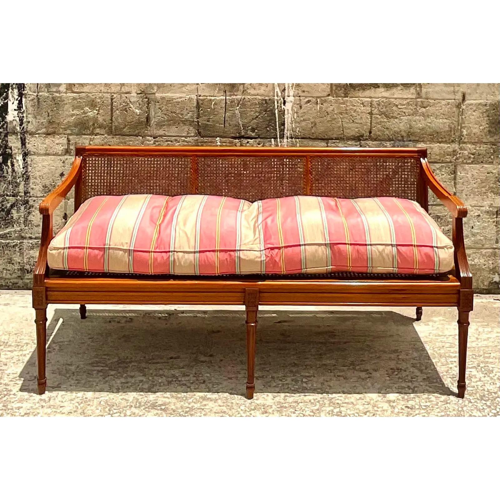 Fantastic vintage Coastal settee. A brilliant 19th Century piece in Brazilian Mahogany with inset cane panels. Gorgeous striped Colefax and Fowler Down filled cushion. Acquired from a Palm Beach estate.