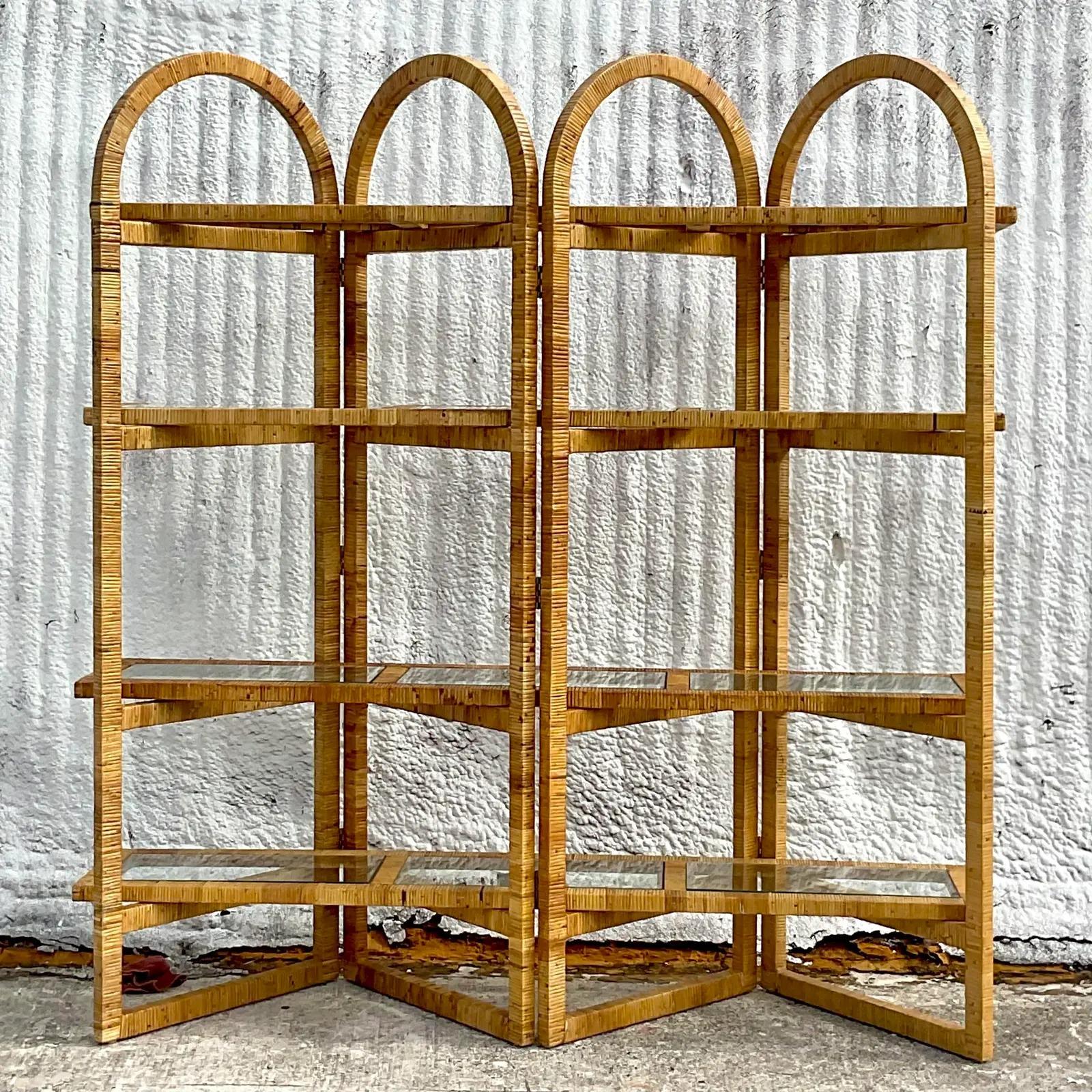 A fantastic vintage Costal wrapped rattan etagere. Beautiful arched design in a chic folding frame. Inset shelves that rest on the arch joints. Acquired from a Palm Beach estate.